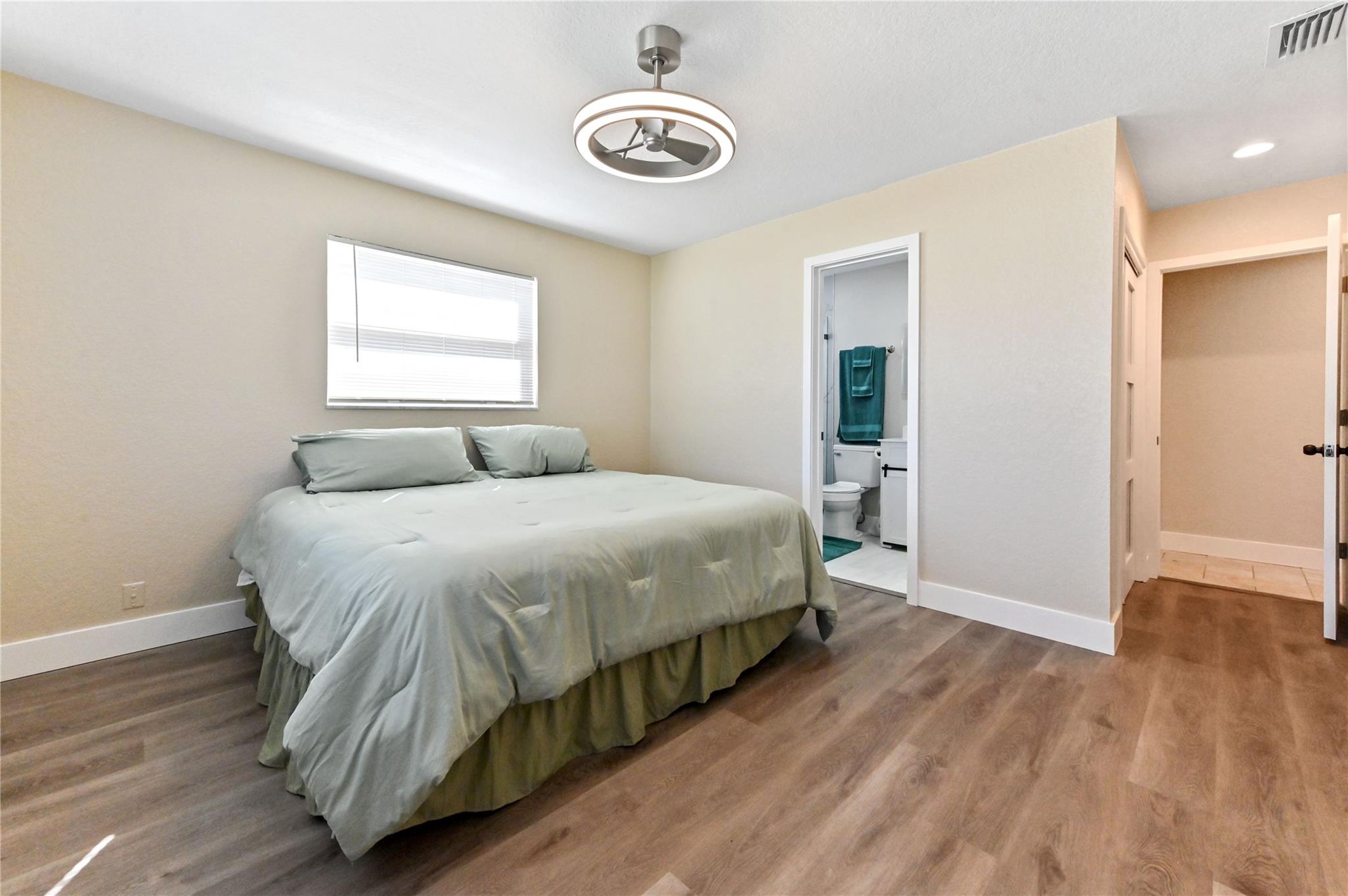 Primary bedroom with designer light fixture/ceiling fan
