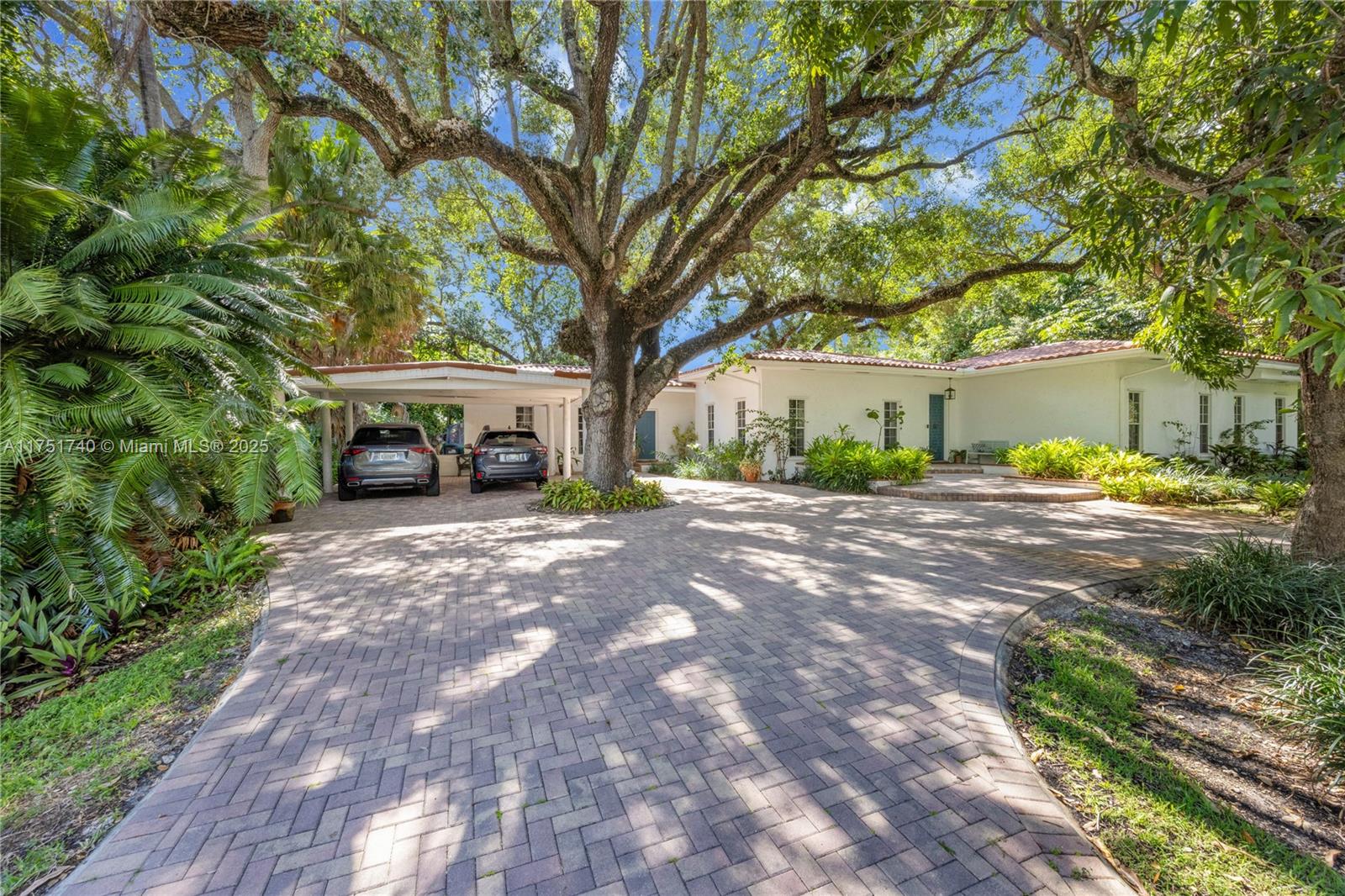Welcome to 14345 SW 72nd Ct in Palmetto Bay, just moments from A+ Miami schools! This updated, elegant home sits on a 15,210 SF lot and boasts an open, contemporary design with high ceilings and spacious living areas. The 4BR/4.5BA home features formal living and dining rooms surrounding a striking glass atrium with a mature oak tree and lush plantings. The kitchen with breakfast nook opens to the family room and offers views of the patio, pool, and yard. A gracious master suite includes a spa-like bath and spacious closets. Three additional en-suite bedrooms complete this one-story beauty. Outdoors, mature oak trees enhance the property’s charm. Additional highlights & upgrades include: new wood floors, custom bookshelves, large laundry room, circular driveway, and carport.