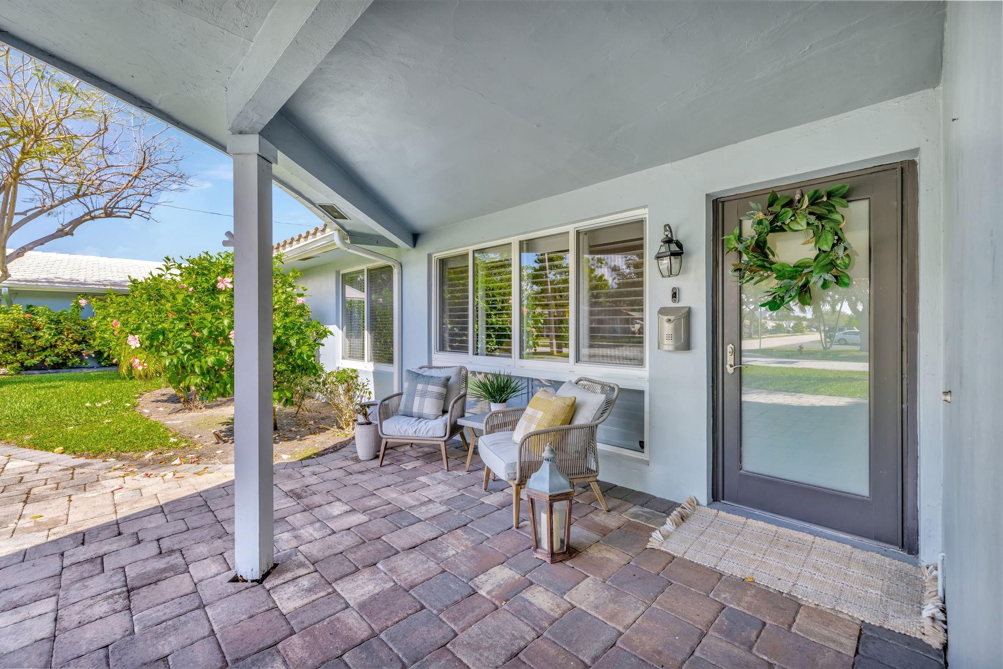 The front porch and covered entrance, offering the perfect spot to relax and enjoy the peaceful neighborhood.