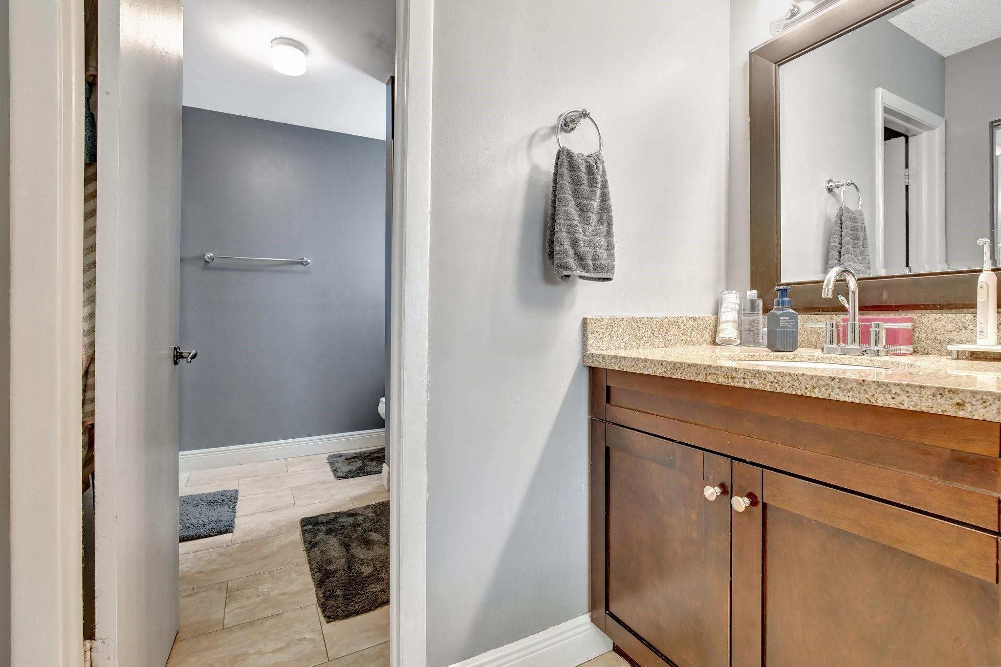 Primary Bathroom with sink area separate from tub, toilet and shower