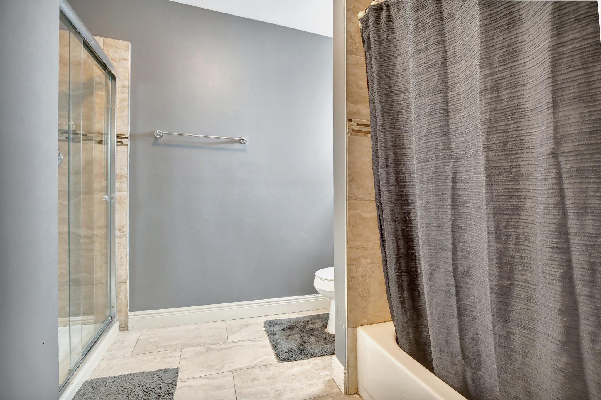 Primary bathroom has separate shower and tub/shower combo