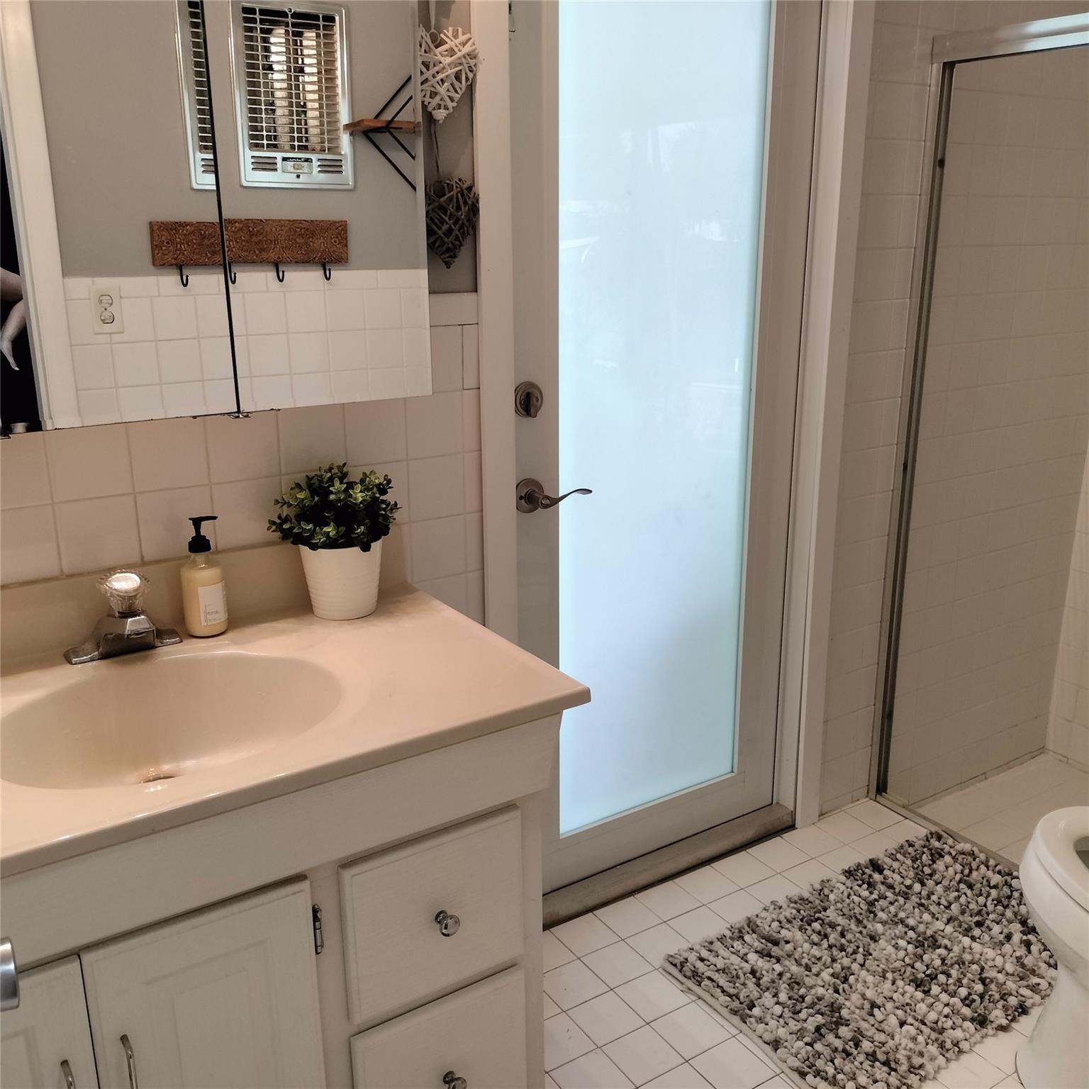 Cabana bathroom with door to rear patio.