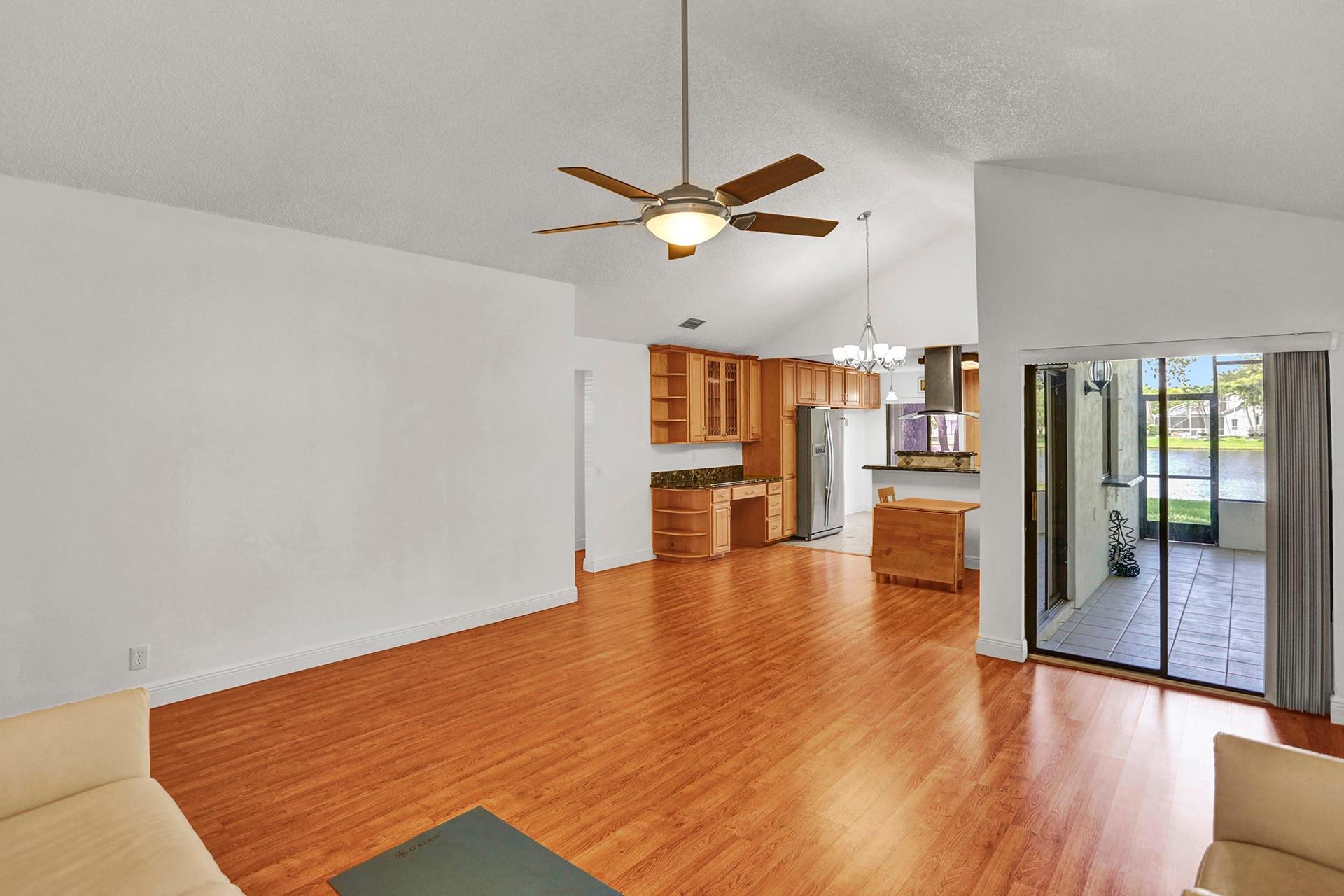 Livingroom with kitchen view and bedroom hallway