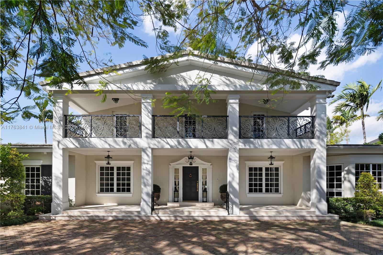 Tucked away behind a private gated entrance, this stunning 9,148 SF storybook estate spans 37,358 SF of lush, manicured grounds with a remarkable 256 feet along the Coral Gables Waterway. A Chicago brick driveway leads to the classic grand residence where elegance meets comfort. Inside, marble & cherry wood floors flow in sunlit spaces, while the impact windows and French doors reveal a resort-style picturesque backyard. A sprawling terrace surrounds the saltwater heated pool, offering many spaces for al fresco dining and lounging, overlooking serene waterway. Entertain in style with walk-in wine cellar, chef’s kitchen, and lavish primary suite. With 5 bedrooms, service qtrs., cabana, 2 car-garage, whole-house generator & expansive gardens, this is a rare retreat in a prestigious setting.