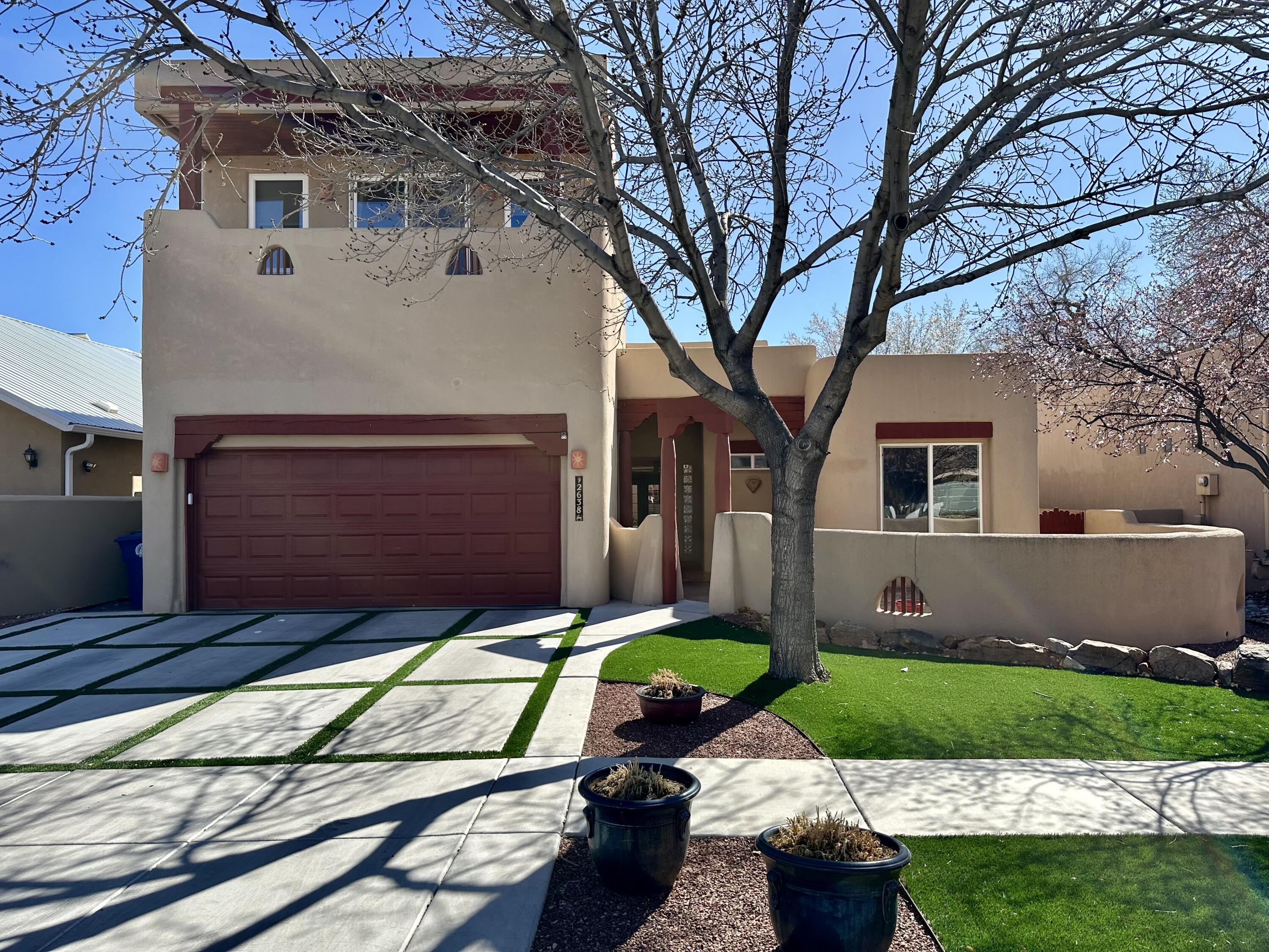 Under Contract, Taking Backup Offers. Cottonwood-lined streets welcome you home in a gated community just minutes from Old Town, the ABQ Bio Park, the Zoo, and downtown. This beauty features high ceilings, an open floor plan, and custom features throughout. Saltillo tiles, hand-carved posts, vigas & corbels bring a touch of southwestern sophistication. Three bedrooms on the main floor, including the primary with a gas kiva fireplace, a full on-suite bathroom, double sinks, and two closets. The front bedroom has its own entry door to the front courtyard. The backyard features a covered gazebo, putting green, and raised garden beds.