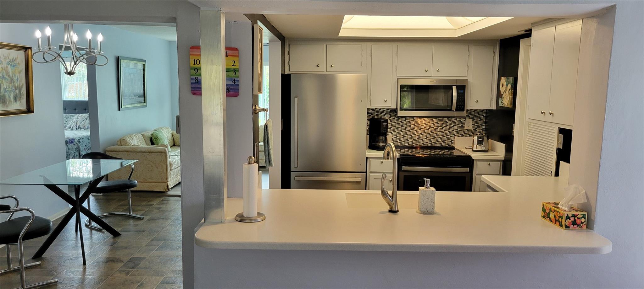 view from Florida Room to Dining Area and Kitchen