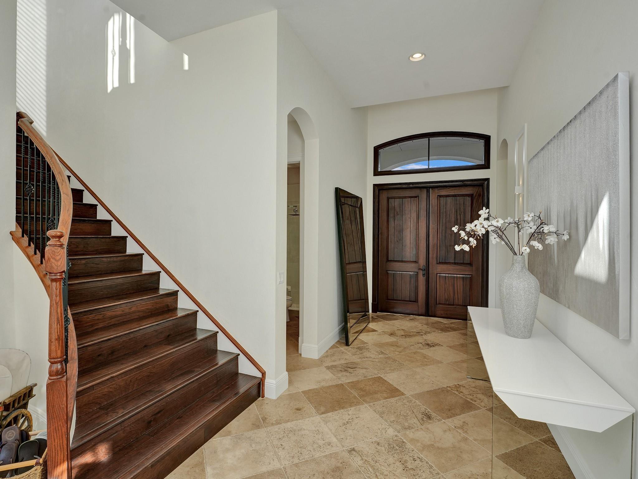 When you enter, to your right, you'll find a guest bedroom and bathroom — a very convenient setup, providing them with private space, while the rest of the family enjoys their living quarters upstairs.