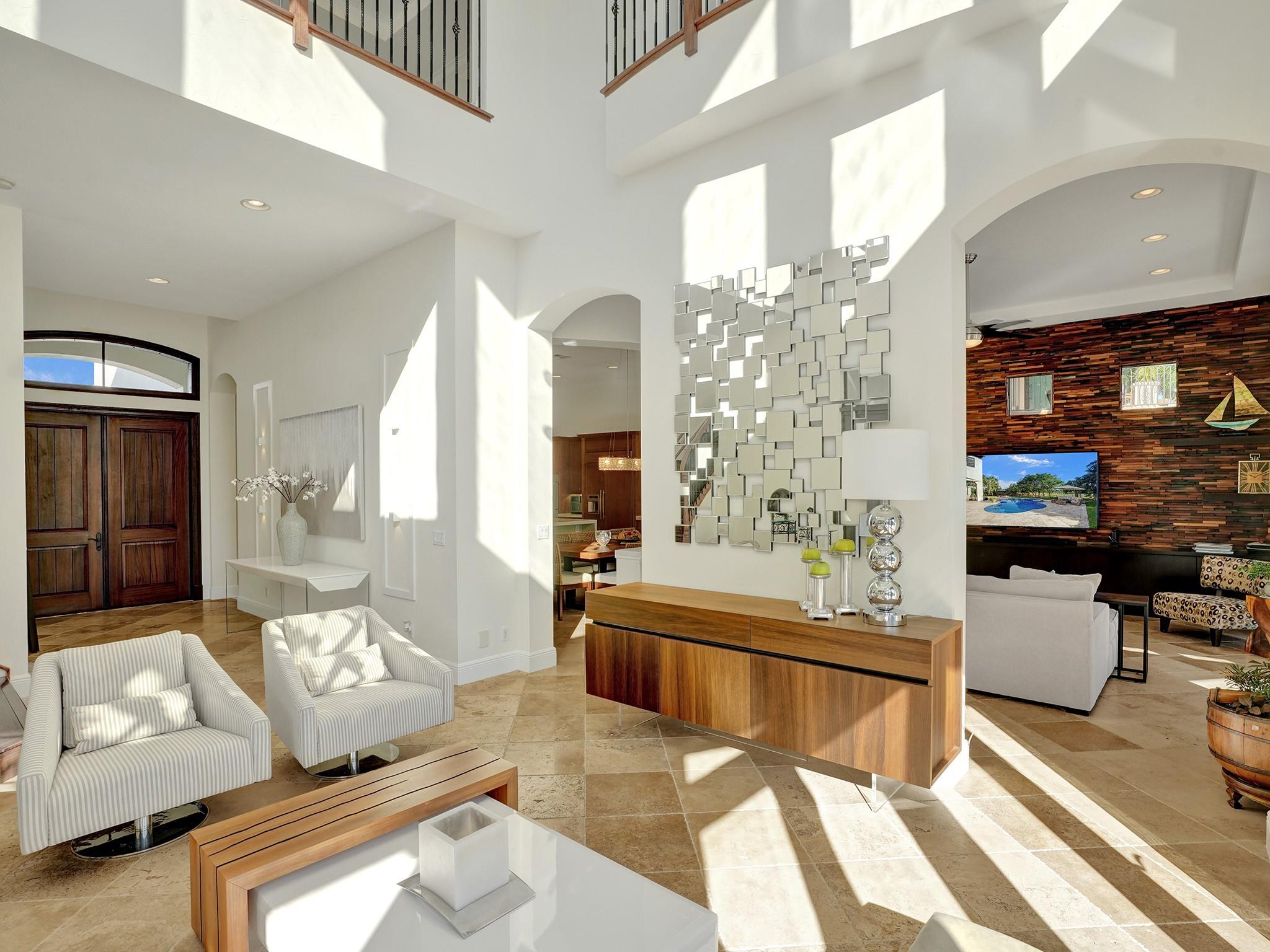 When you enter on the left, you have access to both the kitchen, dining room, and the family room — all are adjacent rooms that enjoy views of the beautiful yard.