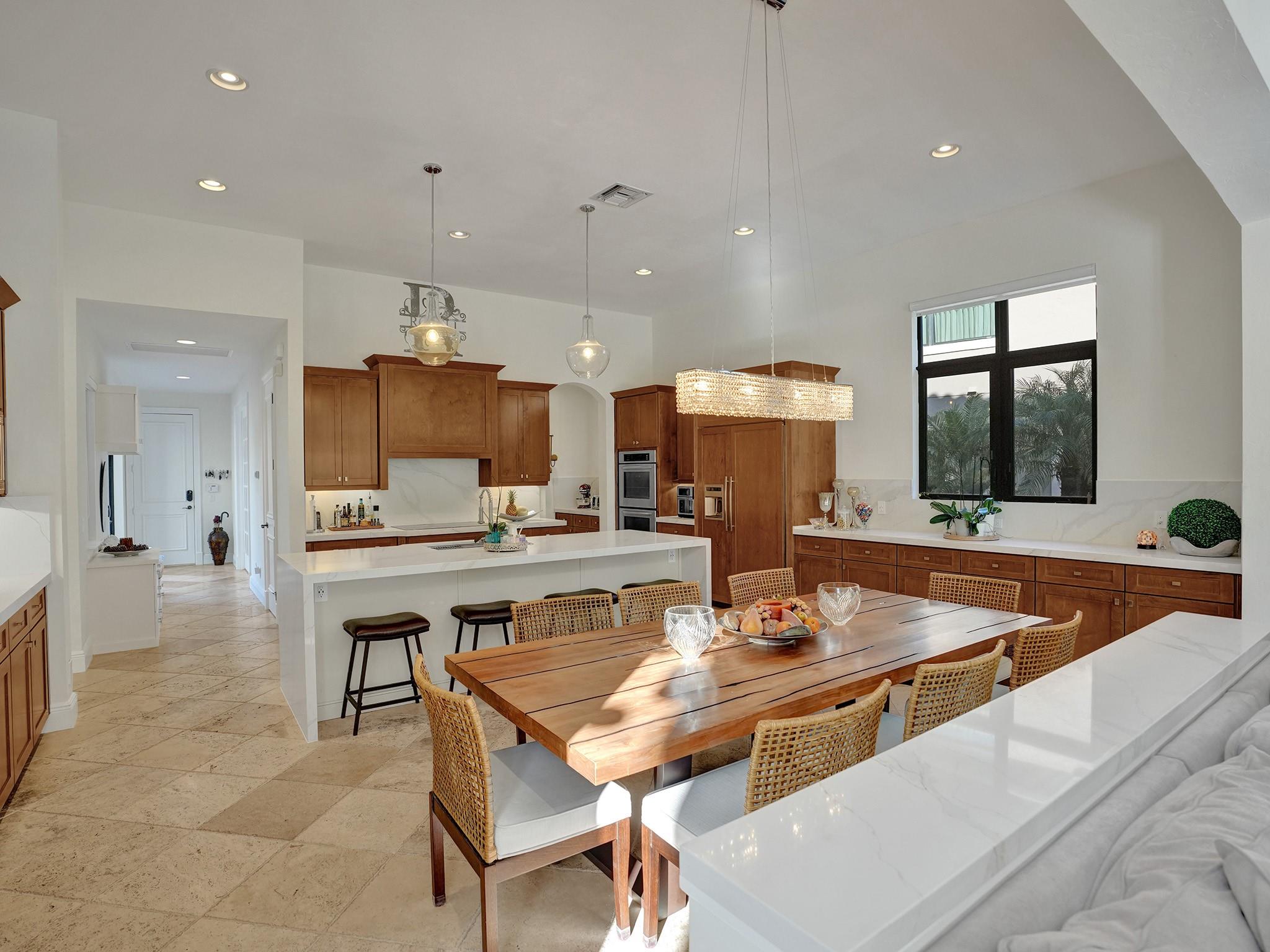 Embrace the warmth of this kitchen, where rich wood cabinets beautifully contrast with the sleek white countertop.