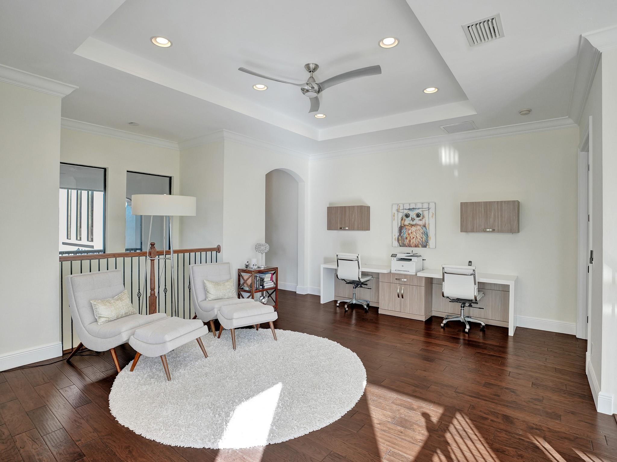 A loft divides and connects rooms, serving as a central area. It also features built-in desks.