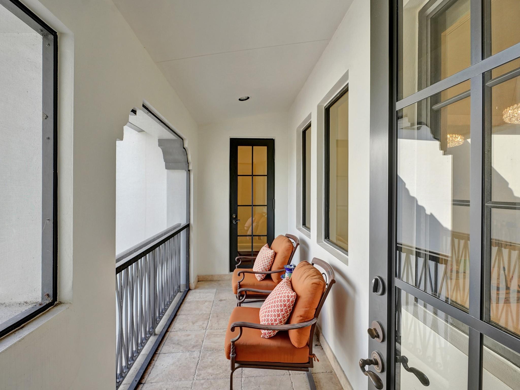 Connecting balcony from the bedroom faces the street and leads to the hallway accessing the 5th bedroom/game room.
