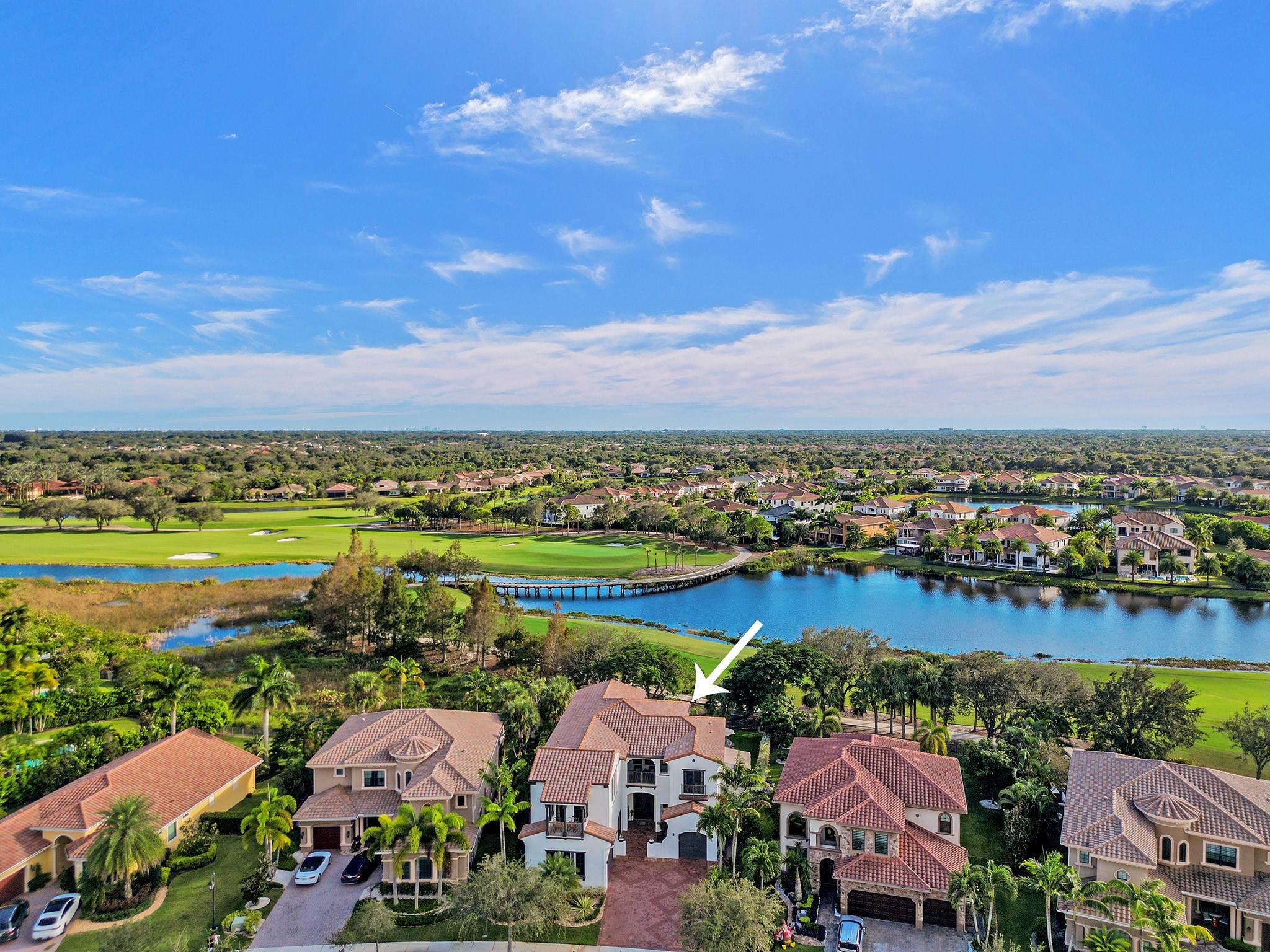 Expansive views overlooking the lake and golf course, with a charming bridge adding to the picturesque scenery.