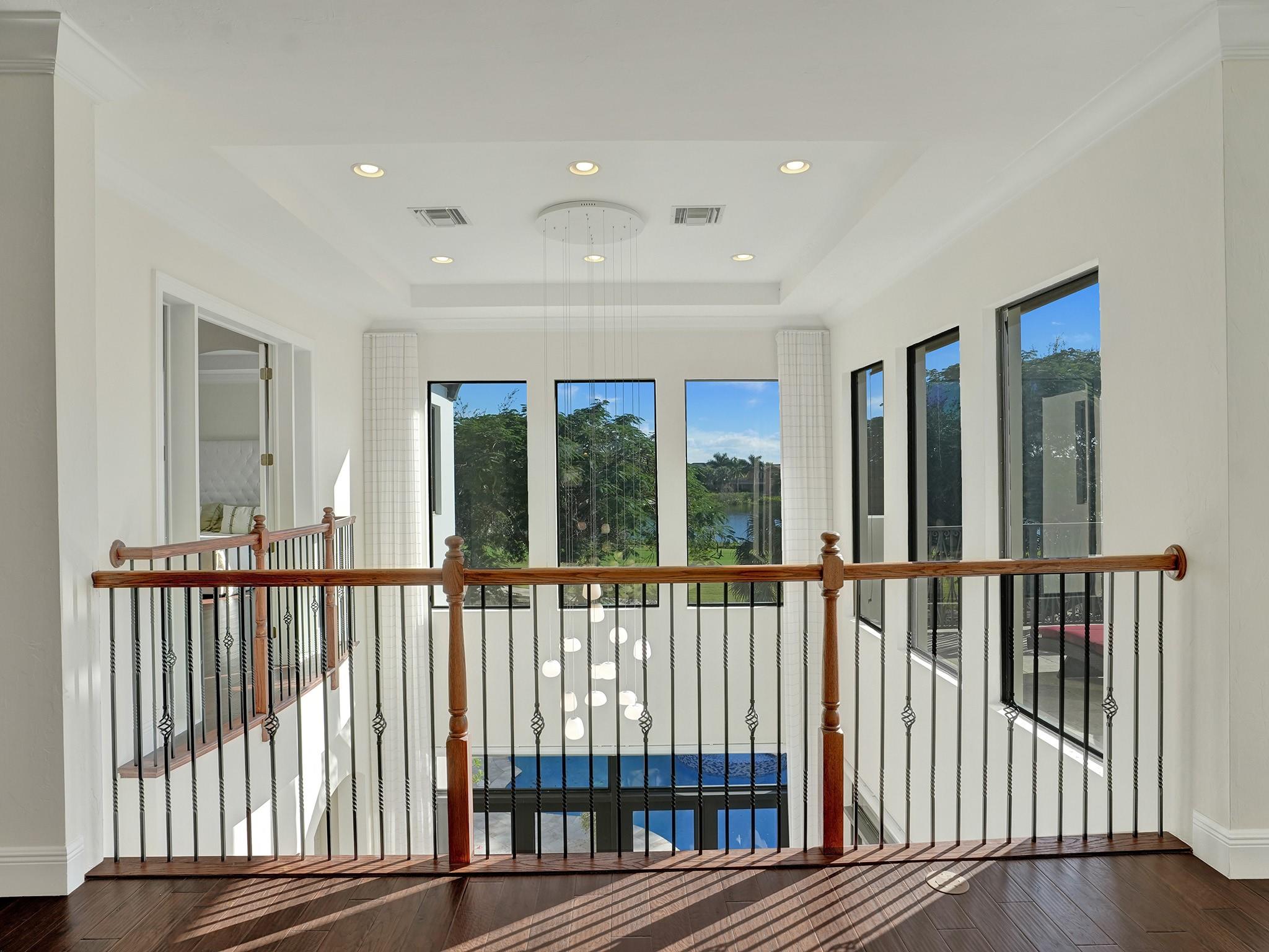 The view from the loft showcases an abundance of natural light flooding into this home.