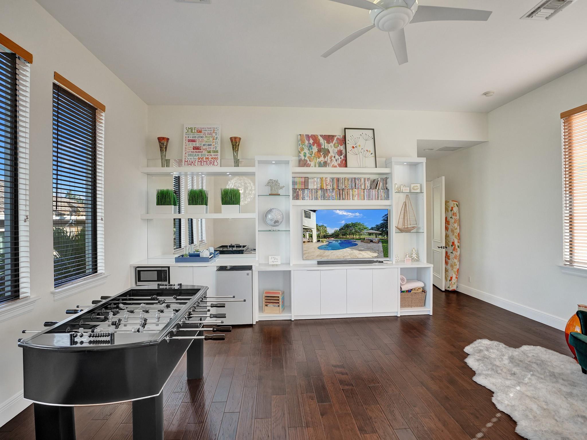 Beautiful built-in closet in the game/media room, complete with fridge and microwave for a fully enjoyable entertainment experience.