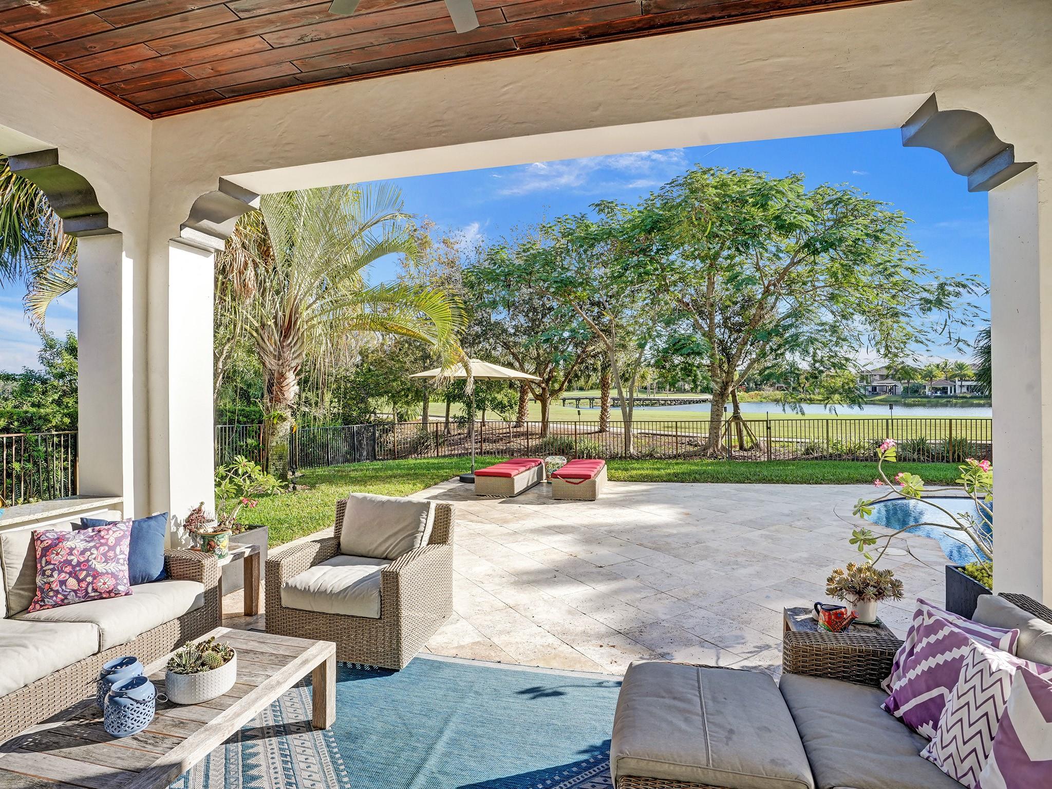 Enjoy the golf view from the covered patio with a wood panel ceiling, showcasing the consistent attention to detail in this home.