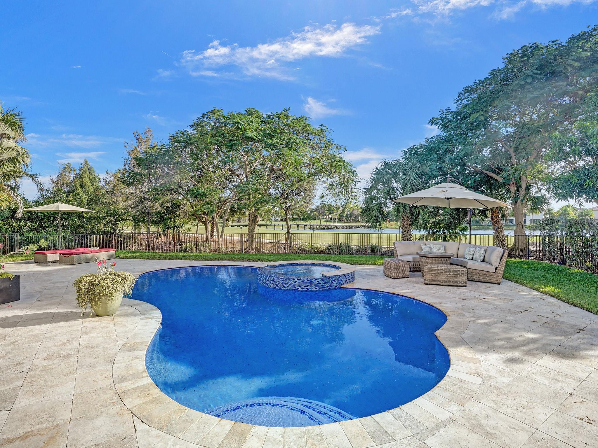 The expansive terrace and gorgeous new pool (with a rich blue color, heater, and saltwater system), elevate the endless views of the golf course and serene lake.