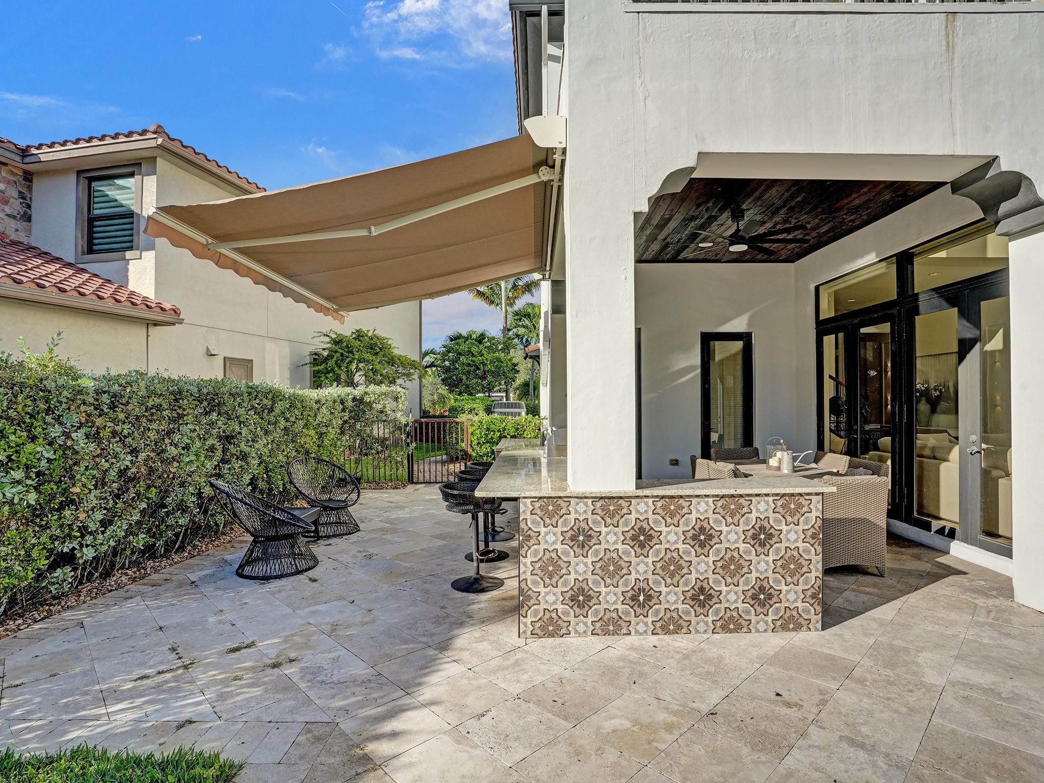 The outdoor kitchen is a significant addition to the house, almost like a separate room in itself.