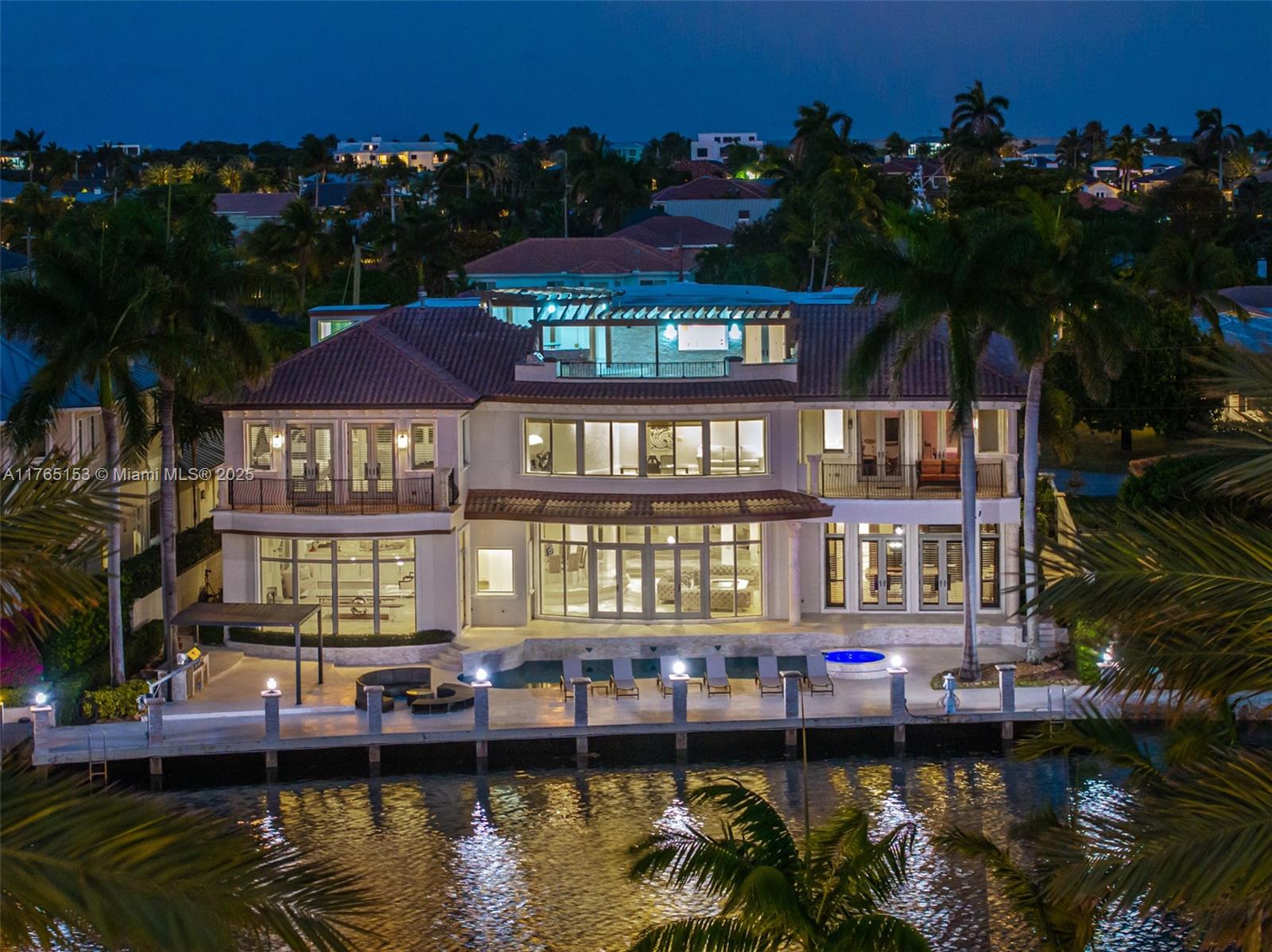 This stunning Mediterranean estate in Lighthouse Point offers 9,000+ sq. ft. of luxury and 100+ feet of water frontage on one of the deepest channels in the neighborhood—ideal for boaters. Upon entry, grand marble butterfly staircases impress. The home features 5 bedrooms, 6.5 bathrooms, a movie theatre, billiard's room with private bar, chef's kitchen, and resort-style saltwater pool & jacuzzi. The master wing spans over 2,000 sq. ft. with a private office. Additional amenities include a sauna, outdoor lounge, whole-house generator, and an elevator for easy access to each floor. Perfect for family living and entertaining!