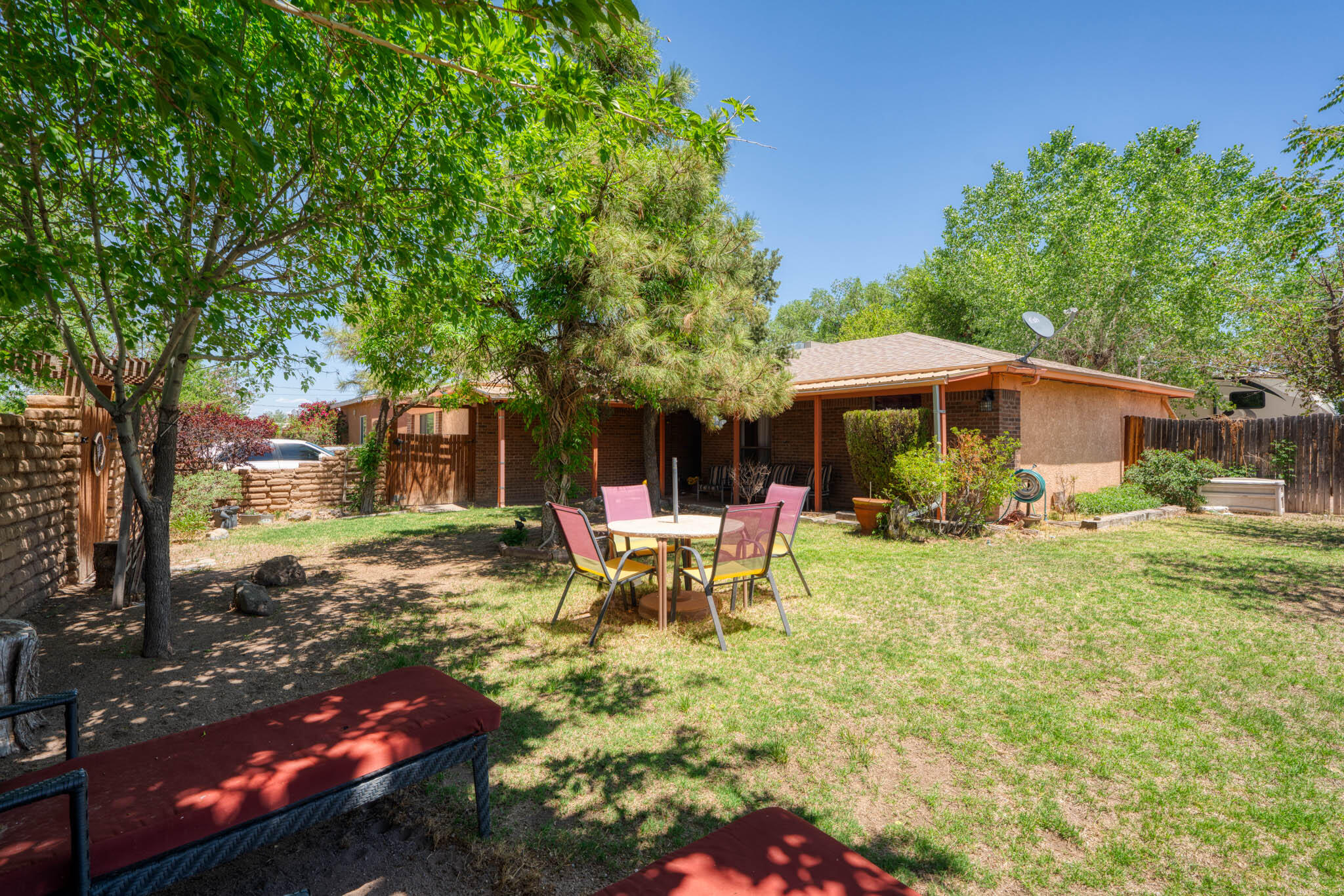 This charming North Valley home is ready for new owners! This great property offers, 3 bedrooms, 1.75 baths, 2 living areas and 1,735 SQFT. Updates include: a new front porch(2023), laminate flooring (2023), Carpet (2025) and a roof (2020). Enjoy outdoor living with the covered patio, backyard access, and two storage sheds. The front courtyard features beautiful exposed Adobe, perfect for creating a private retreat. Additional highlights include a new water heater (2024), a gas stub for the backyard patio, and a Master Cool system. Conveniently located less than a mile from I-40 on a desirable corner lot, this property is not within an HOA or PID restrictions. Don't miss out on this amazing opportunity!