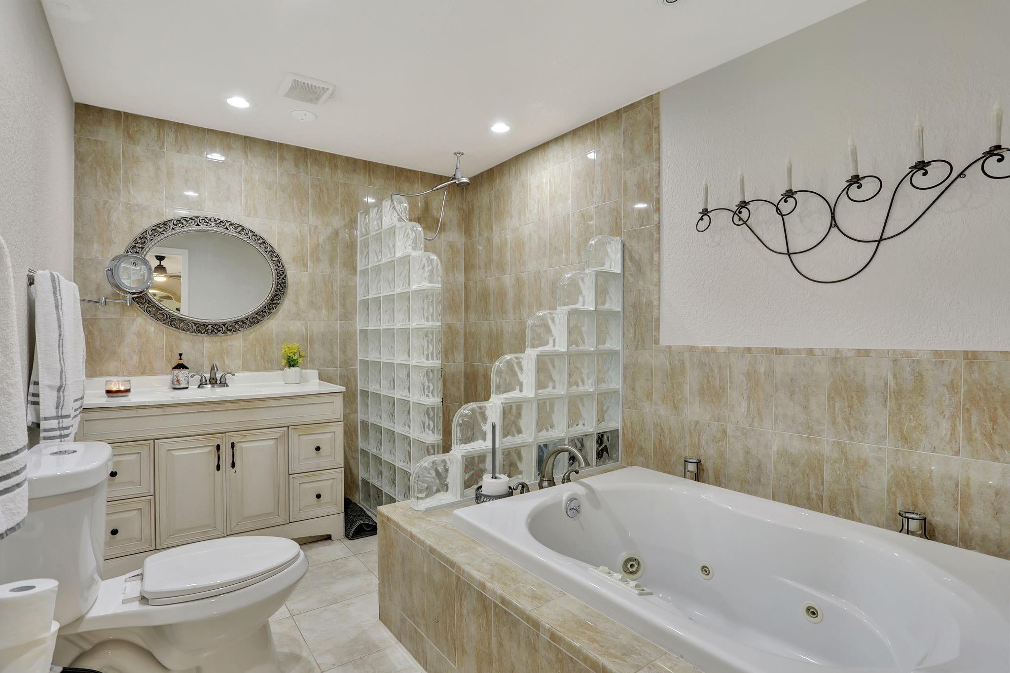 Primary bathroom with jacuzzi bath & shower