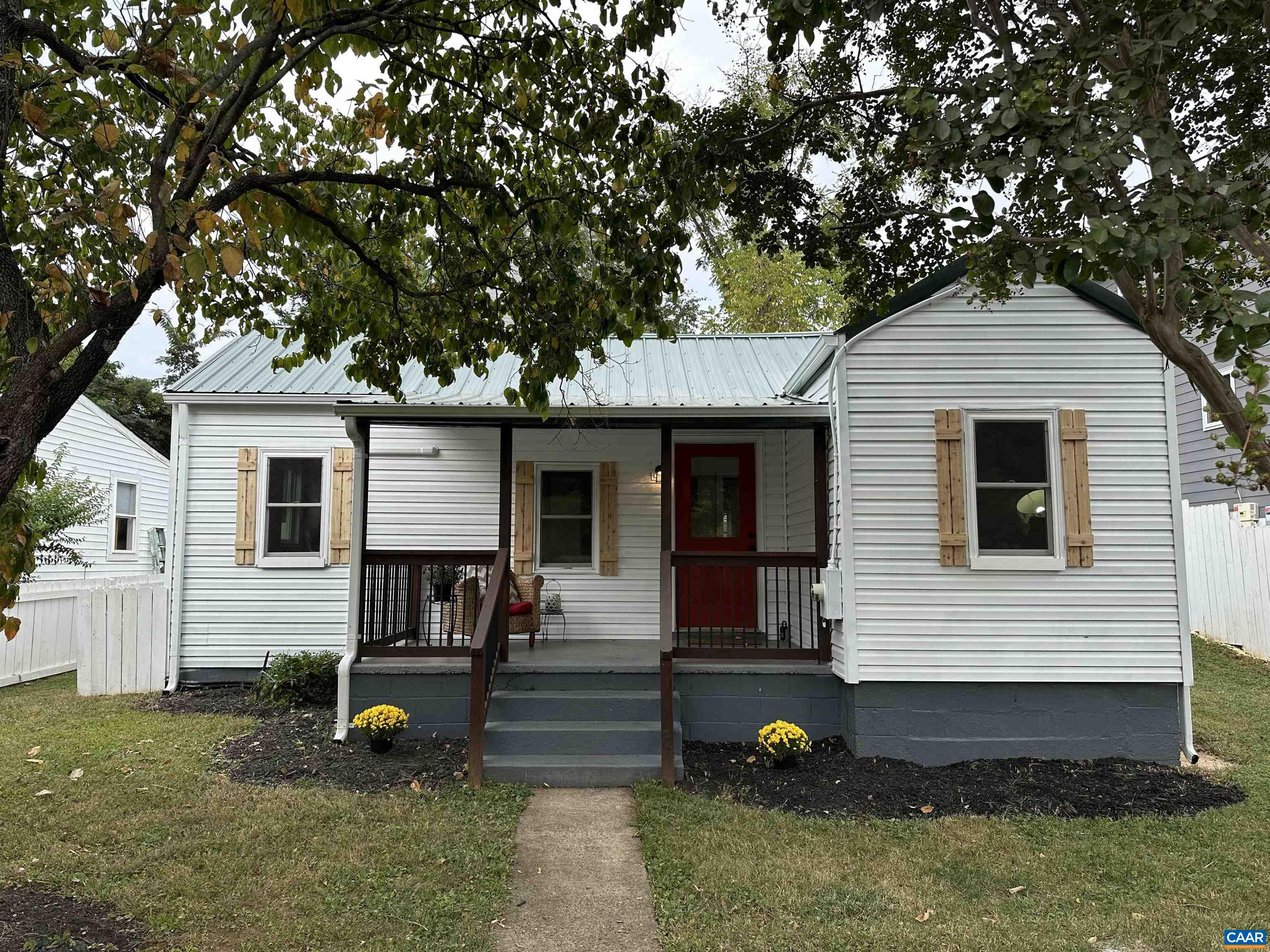New Price! This darling Belmont cottage packs a punch! You will adore the white picket fence the surrounding the front yard, and the covered porch where you'll enjoy the view of Carter Mountain and watch baseball games right across the street at Quarry Park. The new metal roof adds to the charming exterior style and vintage flair.  Inside, the home has been completely renovated and features modern conveniences throughout.  New white shaker cabinets are found in the kitchen plus sleek stainless appliances, and a large tiled shower in the bathroom. Ductless HVAC system was added for heating and cooling. There’s even a spacious mudroom off the back with a sliding barn door. At 850 square feet, it's cozy but smartly laid out with 2 bedrooms plus an office. Just 1 mile to the Downtown Mall, minutes to UVA, and around the corner from I64, it's a great location! If you're looking for an affordable, low-maintenance, move-in ready home in a fantastic location, this one's got the charm and the updates to match. Don't miss this opportunity to see this one before its gone!