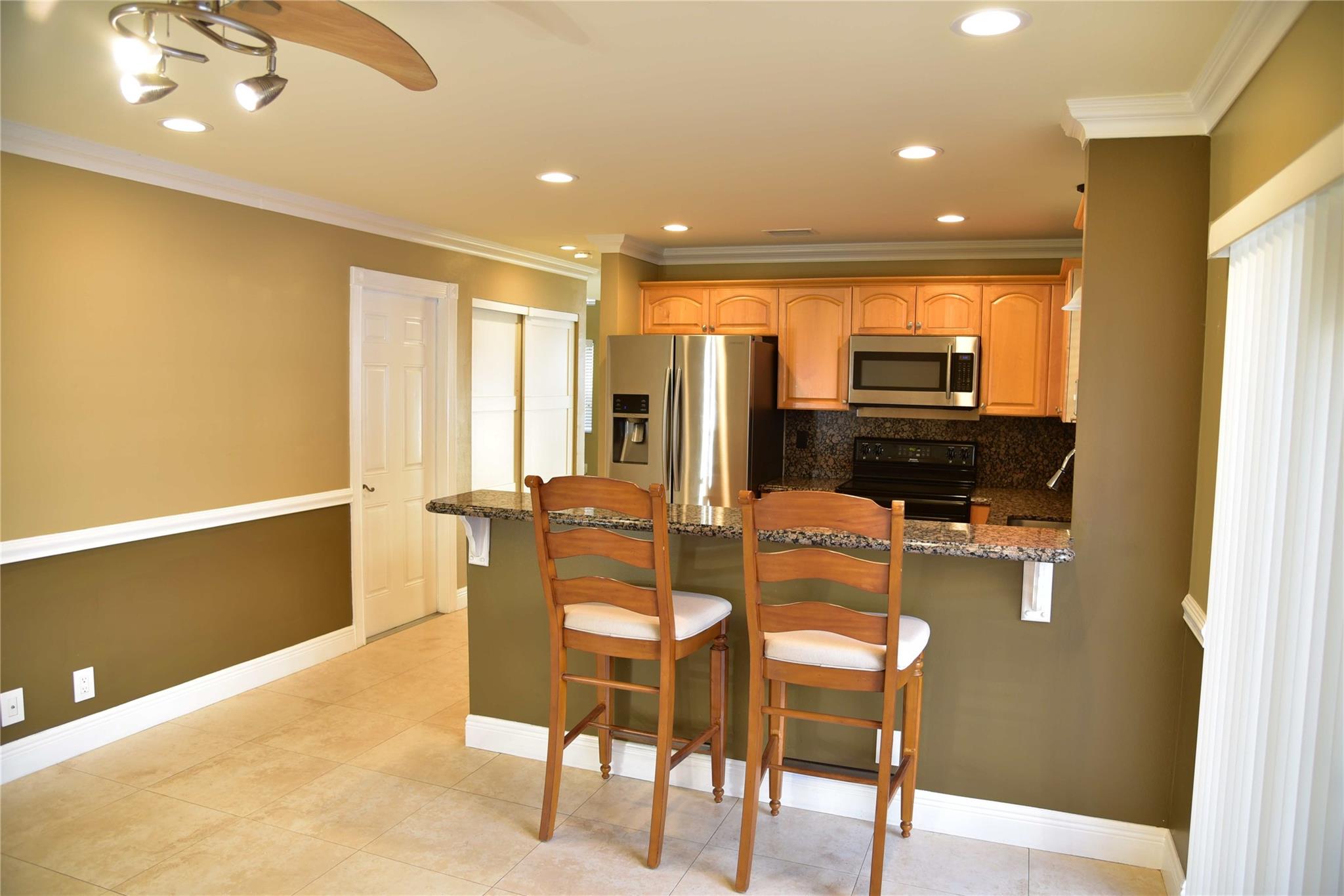 Granite Breakfast Bar,crown moulding, and chair​​‌​​​​‌​​‌‌​​​‌​​‌‌​‌​‌​‌​​​‌​‌​​‌‌‌​​‌ rail