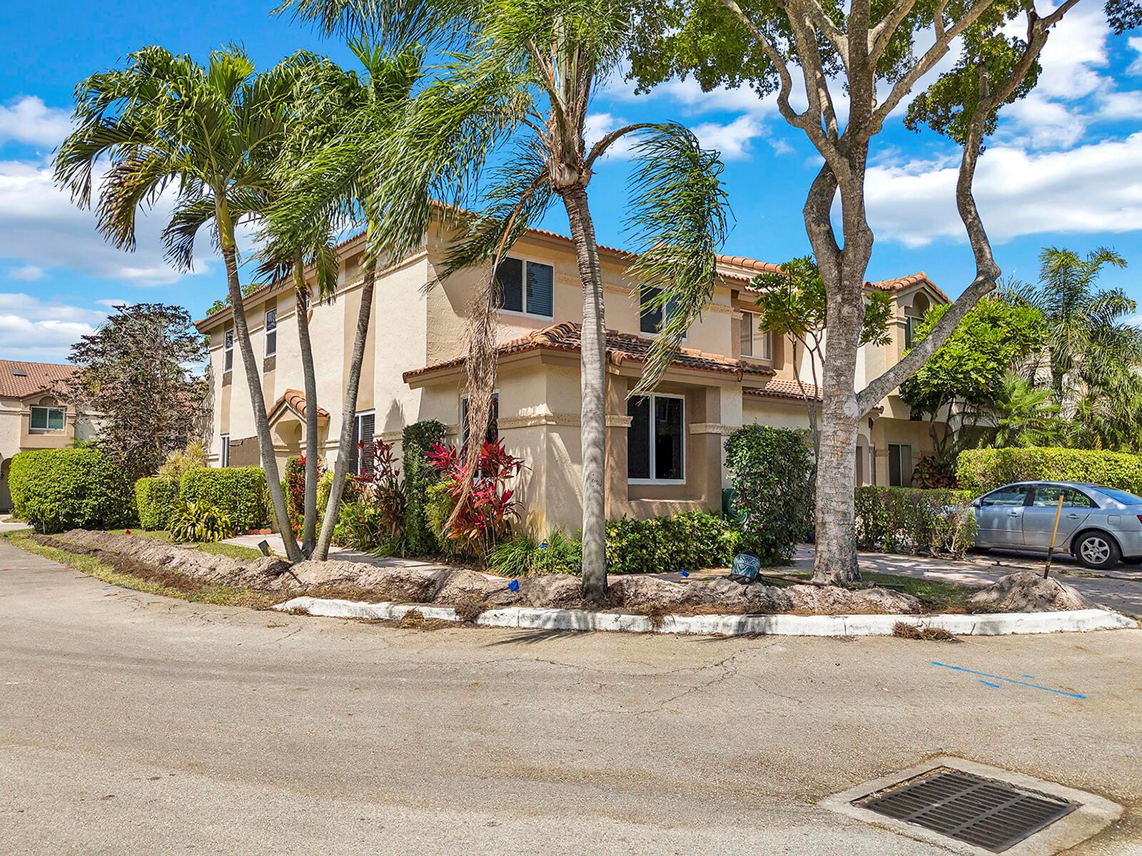 Welcome to this beautifully expanded 3BR, 3.5BA home on a desirable corner lot in one of the area's top gated communities. With 2,400 sq ft of living space, it offers a flexible layout, upgraded features, and room to make it your own.  Large primary suite with renovated suite featuring dual sinks, soaking tub & shower. New laminate floors, wood stairs, no carpet. Hurricane-impact windows. Patio, backyard with fruit trees, pool/lake access. Near A-rated schools, shops, beach, highways & PBI. Investor-friendly! With HOA approval, the property may be rented up to four times per year with no waiting period--a rare and valuable option in today's market.  bring your offer!