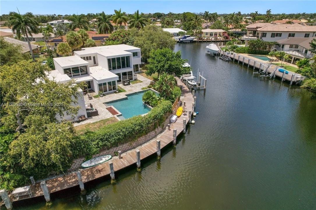 MAGNIFICENT LIGHTHOUSE POINT WATERFRONT BOATERS DREAM HOME! MODERN, GORGEOUS POINT LOT. DEEP WATER 197 FT DOCKAGE. AMAZING WALKWAY DOWN TO THE DOCK, NO FIXED BRIDGES, DIRECT OCEAN ACCESS, BIG TURNING BASIN, BOAT LIFT POWER & BUILT-IN FENDERS. THIS ALLOWS FOR MULTIPLE BOATS. RAY OF LIGHTS PRIVATE PANORAMIC POOL WATER VIEW. ROOF & AC 2021. LUSH BACKYARD GARDEN VIEW. BUILT-IN BARBEQUE GRILL ARE WITH FRIDGE. NEWER OPEN GOURMET KITCHEN, TOP OF THE LINE APPLIANCES. LUTRON WIRED SMART HOME, BRAND NEW SPEAKERS & SOUND SYSTEM THROUGHOUT HOME. MOVIE THEATER AREA, LARGE DEN CAN CONVERT TO 4TH BDRM IF NEEDED. GORGEOUS & PRIVATE MASTER SUITE WITH SITTING AREA, HUGE MASTER SUITE WITH WALK IN CLOSET OR YOU CAN JUST ENJOY THE WALLS OF GLASS OVERLOOKING THE POOL. PRIVATE AREA DOWNSTAIRS WITH ADDITIONAL BEDROOMS. ALL IMPACT WINDOWS & DOORS. MINUTES TO THE INTRA, HILLSBOROUGH INLET & LIGHTHOUSE POINT YACHT CLUB.