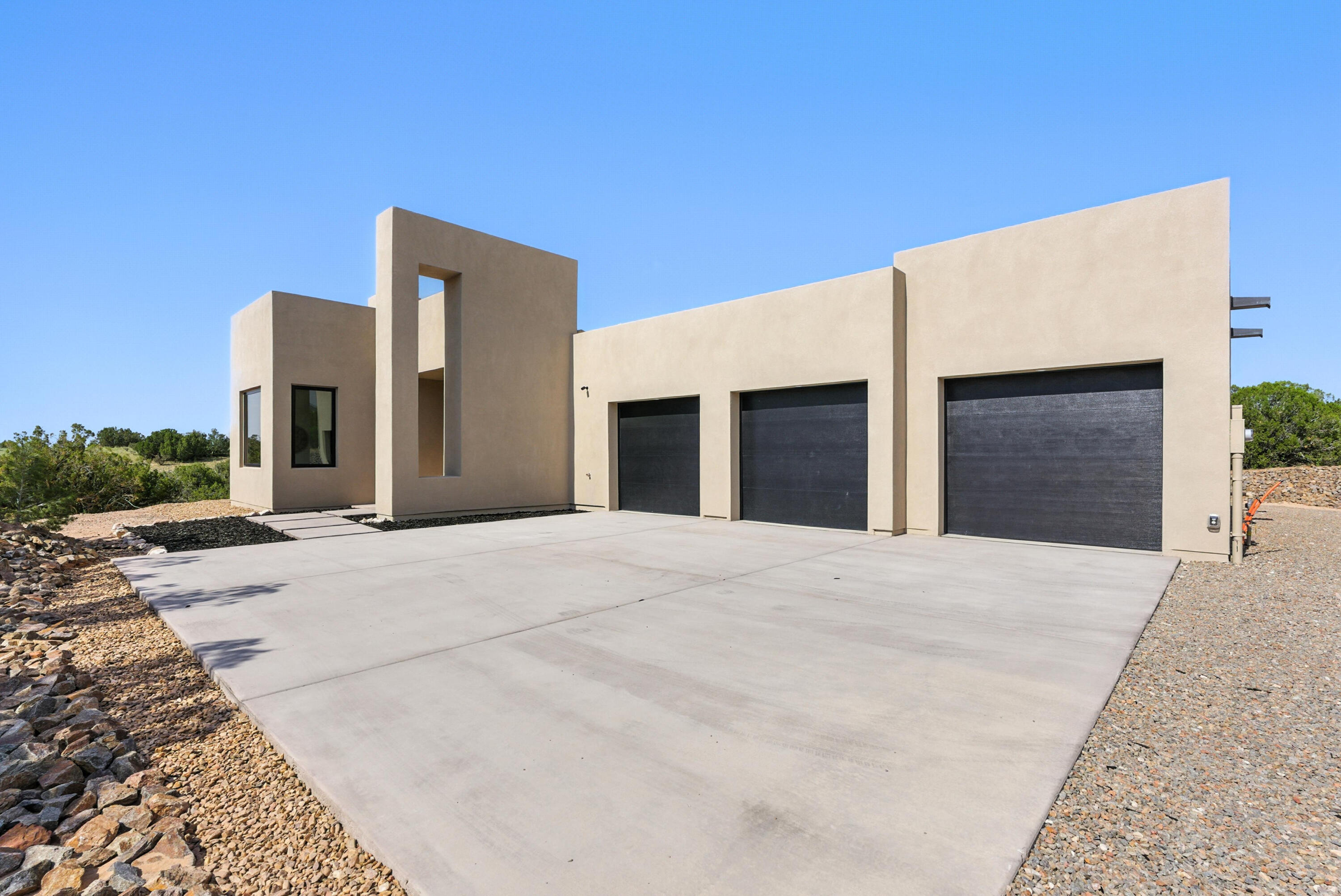 Welcome to this stunning property by Golden Homes. Featuring engineered hardwood floors & beautiful Anderson Windows. Dream kitchen w/Cosmo appliances, 48'' range, granite counters & floating shelves. Large pantry w/custom built-ins.  Primary suite features a luxury bathroom w/tiled steam shower & soaking tub & patio access to hot tub pad with electric. The custom walk-in closet is sure to wow you, built in storage & pull-down rods for convenience.  Relax on the large patio with both incredible views & privacy all around. 850 sq ft 3 car garage w/2 electric car charging outlets & professional floor coating.  Located in the gated Overlook community which offers a pool, hot tub, clubhouse & security. Buyer will have access to preferred rates at Paa-ko Golf Course as well.