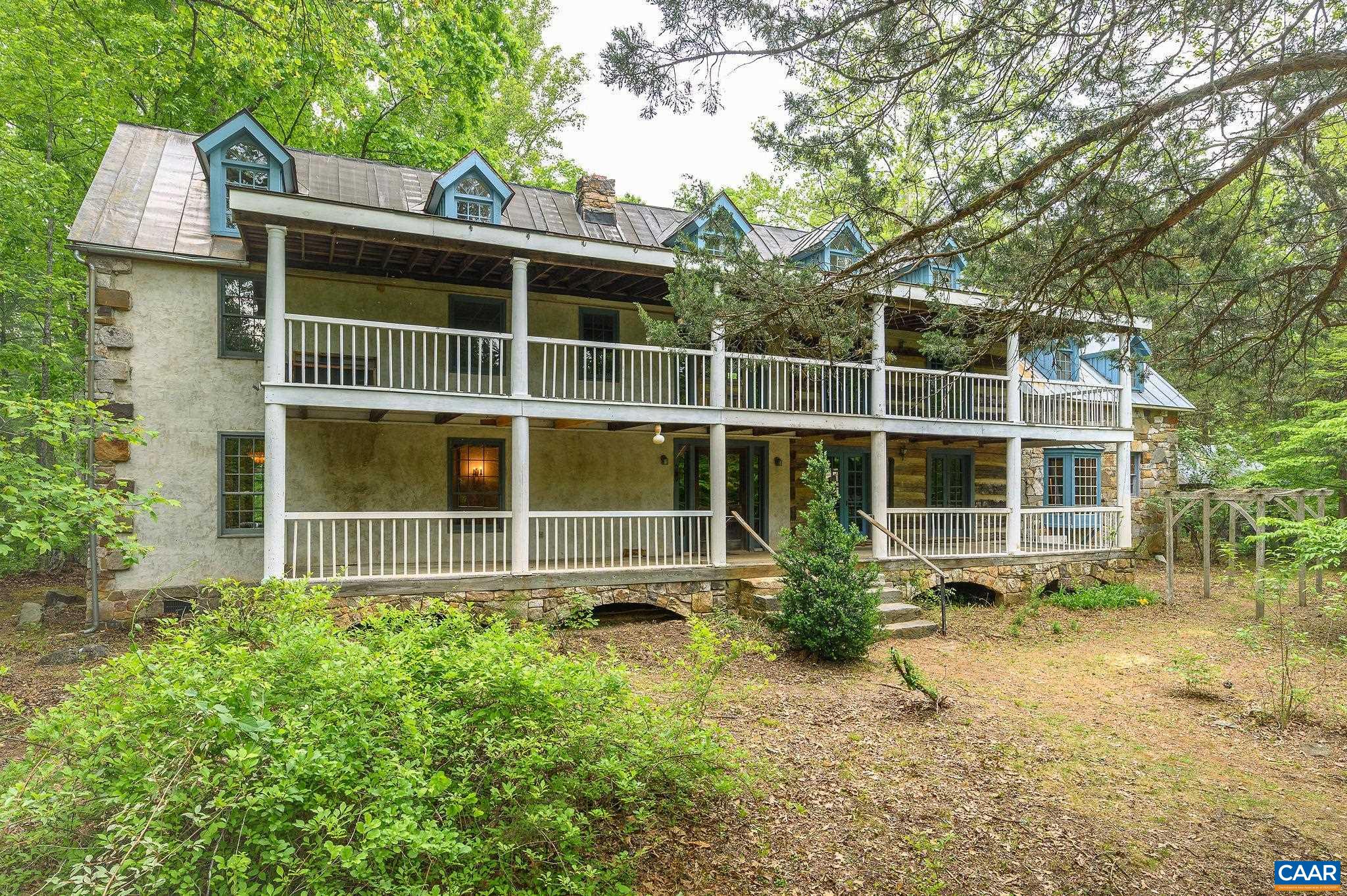 MOTIVATED SELLER! Raven Oak is a rare combination of craftsmanship, history, space, privacy & hidden discoveries built by local builder/craftsman, Charles McRaven. This is McRaven’s hand-crafted, one-of-a kind, home place. With seamlessly married the reclaimed features with the newer parts of the build during construction- 2 hewn log sections & 2 timberframe sections. Much of the structural and finish material is of historic recycled heart pine, chestnut, & heart poplar with the majority of timbers and logs in the house from structures dating from the 1700s and 1800s.  It includes beautiful, intricate stonework constructed with local granite & West Virginia sandstone-there are 2 fireplaces & full chimneys, a notable massive Russian fireplace which heats a large portion of the home, beautiful exterior stonework framing both ends of the house. The kitchen cabinetry of rare American chestnut, copper panels and counter tops, as well as heart pine shelving. On the grounds there are native plantings galore. There are 9 outbuildings including a log chapel that seats 40 people down by the stream. Two additional building rights.  17 beautifully wooded & private acres only 10 mins to the Cville Airport & 23 mins to Cville/UVA.