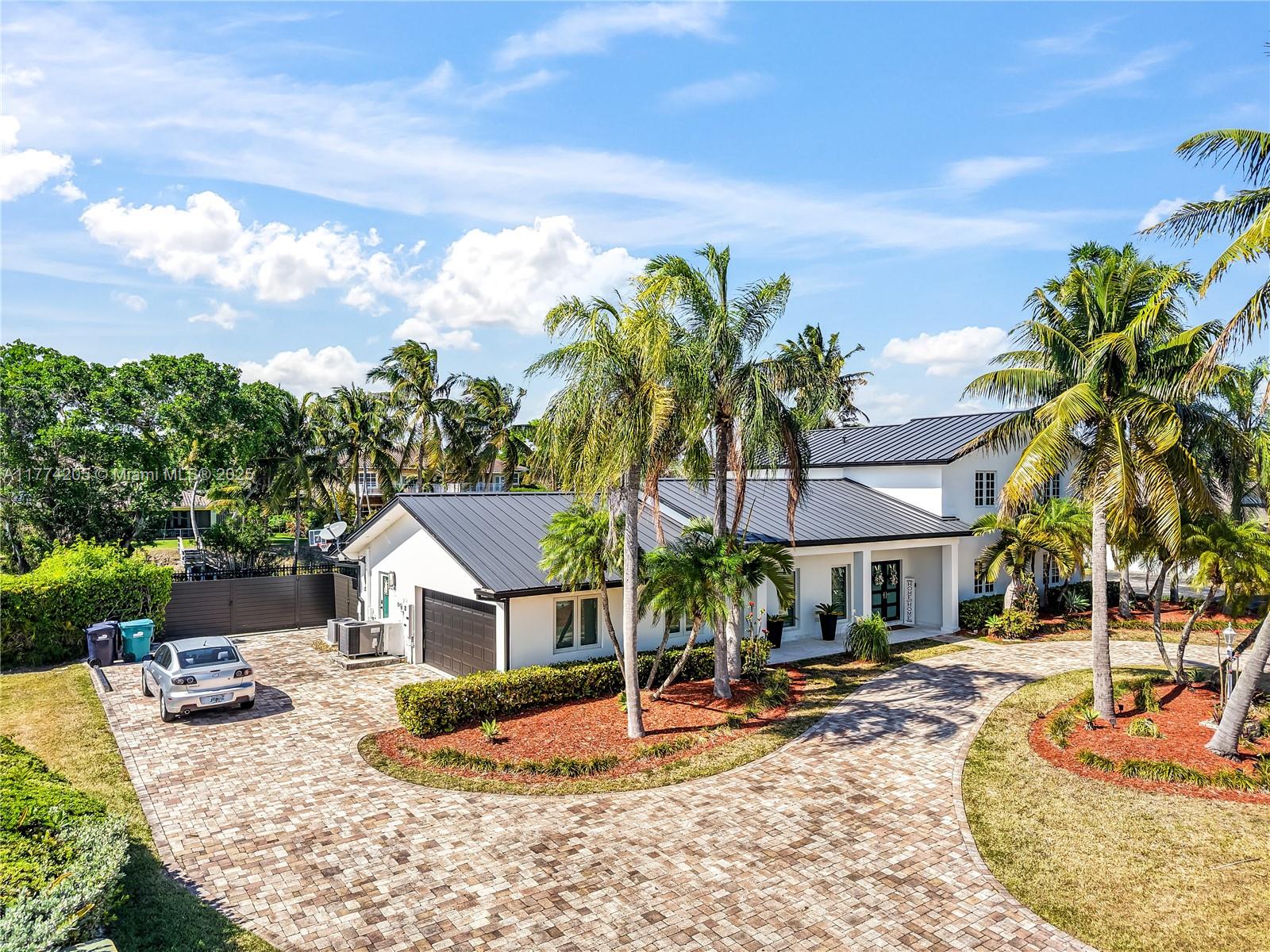 This beautifully renovated 6BR/3BA home in desirable Palmetto Bay offers the ultimate in modern comfort & waterfront living. Enjoy peace of mind w/a brand-new metal roof, impact windows, new plumbing, & new electrical systems throughout. Inside, the home features tile flooring & a flexible layout with the primary suite & two additional bedrooms downstairs, & three bedrooms upstairs, ideal for families or multigenerational living. Cook like a pro in the chef’s kitchen equipped w/high-end Miele appliances, 6-person theater room, custom outdoor kitchen by the pool with sun deck. Smart home features & a home generator. Fully upgraded, move-in ready, & perfect for entertaining or relaxing. Prime location near top schools, parks, and the bay. Experience the perfect blend of luxury & lifestyle.