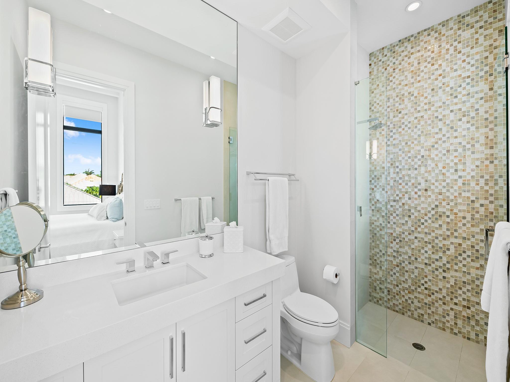 A breathtaking guest suite bathroom offers a serene and elegant retreat for your guests