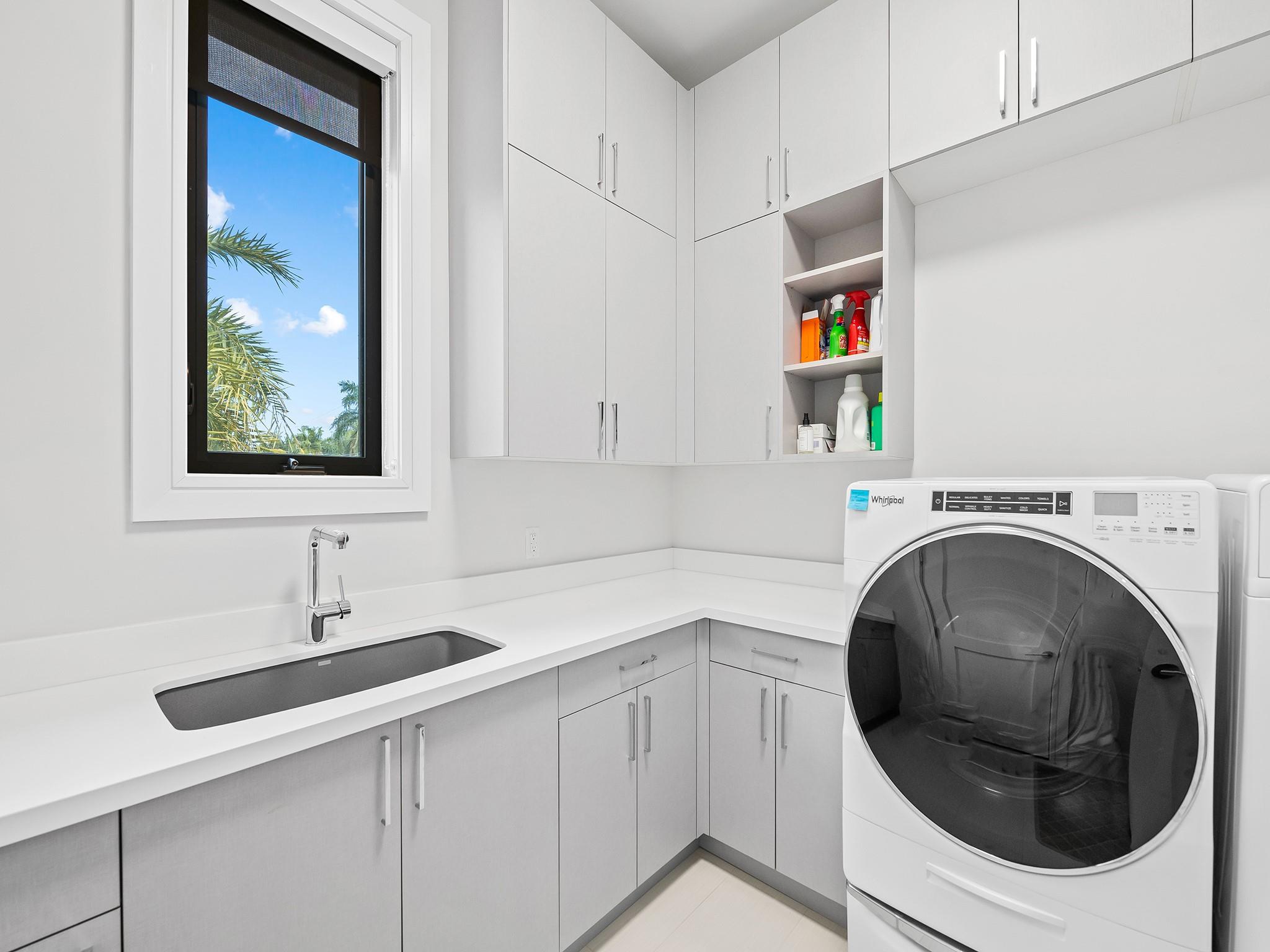 Such a spacious laundry room with plenty of storage and closet space