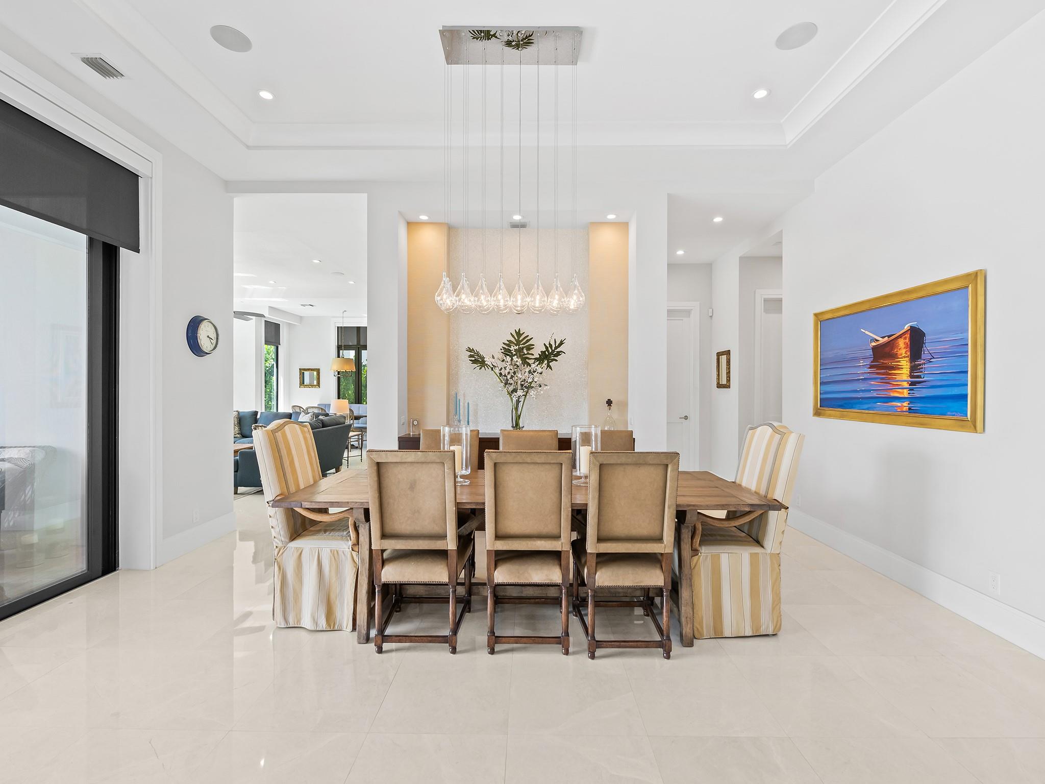 Sophisticated dining area highlighted by a sleek, modern chandelier