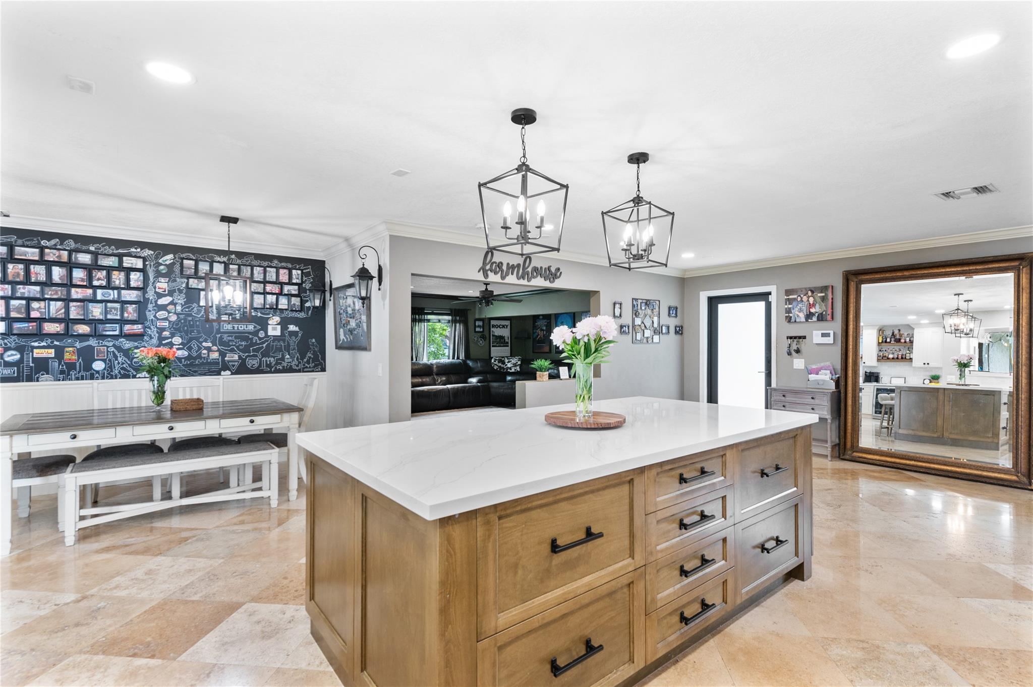 Large Kitchen Island & dining area with view of Theater room & front door entrance