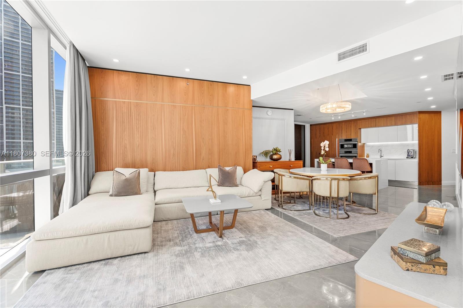 A redesigned 2-bedroom + den with the option to convert into a 3-bedroom, located in the heart of Miami Worldcenter. Unit #1409 features custom doors, handles, flooring, window treatments, millwork, upgraded lighting, wallpaper, built-in storage, and a premium audio system. Enter through a private lobby with secure keycode access, custom finishes, and built-in cabinetry to maximize storage. The residence opens through a foyer hallway which leads you to the bright living areas with water and skyline views. The expansive outdoor terrace, located above the amenity deck, includes a TV and lounge space to enjoy the bay and city skyline views. The residence is fully-furnished and located in the building with the most amenities in the world.