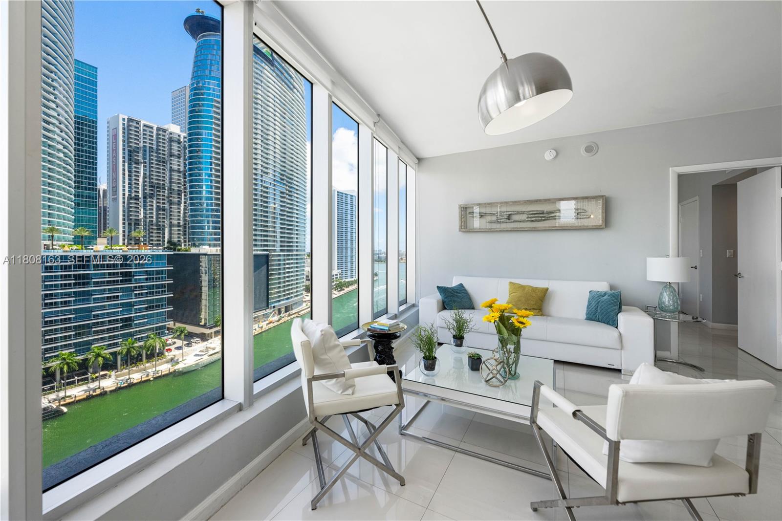 Unit 1604 at 485 Brickell Avenue, located in the Icon Brickell Tower 3 (also known as W Miami), is a 2-bedroom, 2-bathroom condominium offering approximately 1,286 square feet of living space. This corner unit boasts expansive floor-to-ceiling windows, providing panoramic views of the Miami skyline and the Miami River. The interior features designer finishes, including custom window treatments, closets, and mirrors. The kitchen is equipped with high-end Sub-Zero appliances, granite countertops, and a glass cooktop. The unit is furnished and includes in-unit laundry facilities. Residents have access to a range of amenities, such as a state-of-the-art spa and gym, multiple dining options, a rooftop pool, and concierge services.