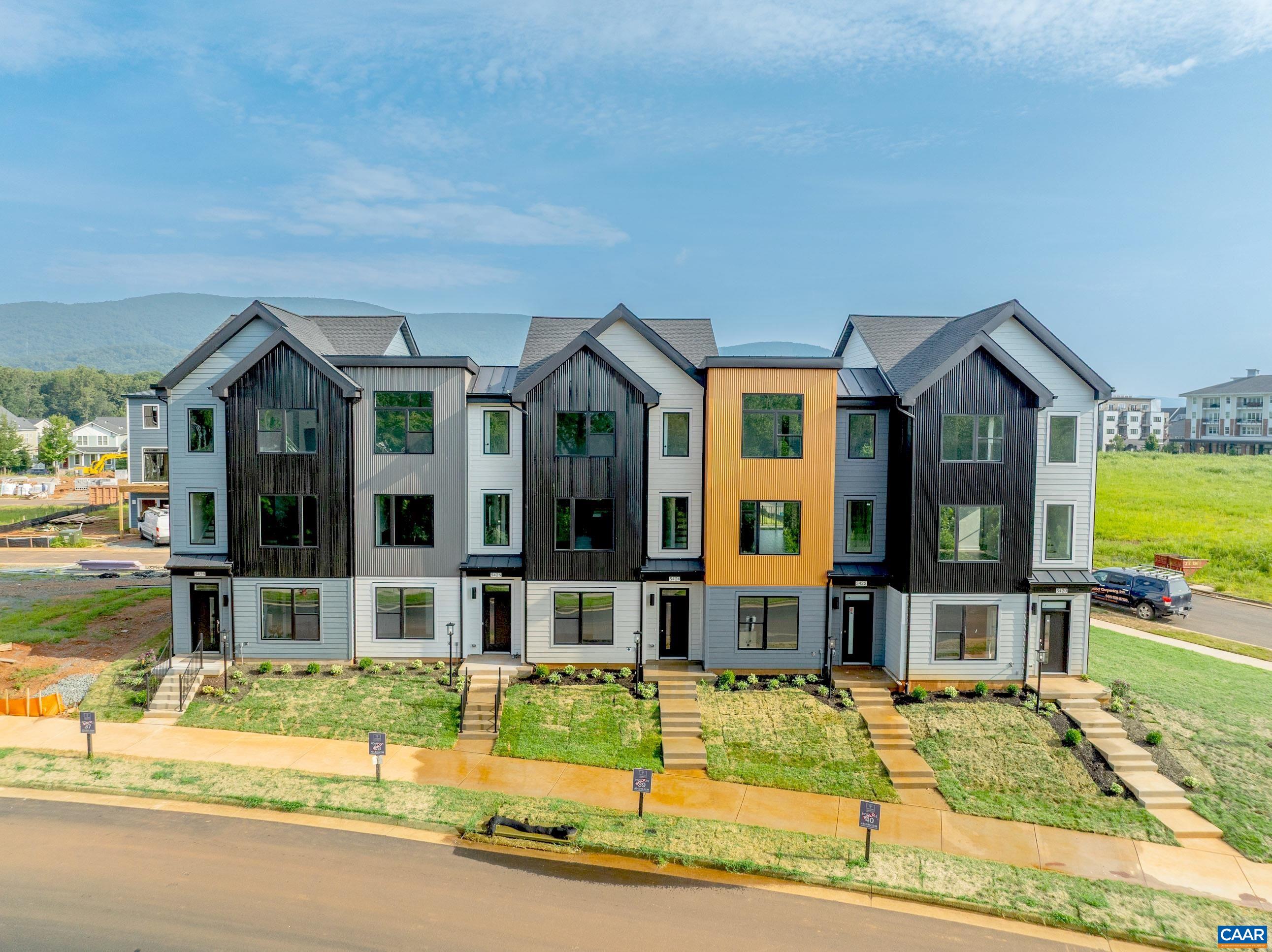 Under construction. November 2025 delivery. Designer selected finishes. The Avon is a modern end-unit townhome thoughtfully designed for everyday comfort and flexibility. On the entry level, you’ll find a study with french doors, a half bath, and a 2-car garage. Upstairs, the main level offers a bright and open layout, with large windows that fill the space with natural light. The L-shaped kitchen features ample cabinetry and a convenient pantry, flowing seamlessly into the dining area and great room. A tucked-away nook off the kitchen adds flexibility—perfect for a home office or additional storage—while the rear deck expands your living space outdoors.  The top level features a spacious primary suite with a vaulted ceiling that adds height and character, along with two additional bedrooms, a full hall bath, and a centrally located laundry room. Old Trail is set against the Blue Ridge mountains steps from dining, coffee shop, ACAC Gym, golf course, schools and more! Every home is Pearl GOLD Certified and HERS scored by a third party to ensure quality, comfort, & energy efficiency.