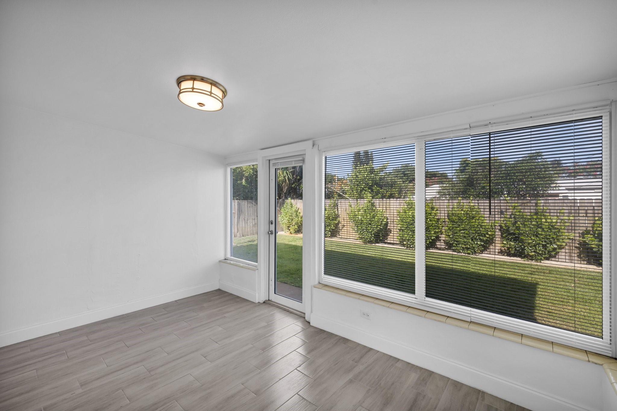 Florida room with impact windows & door to private backyard