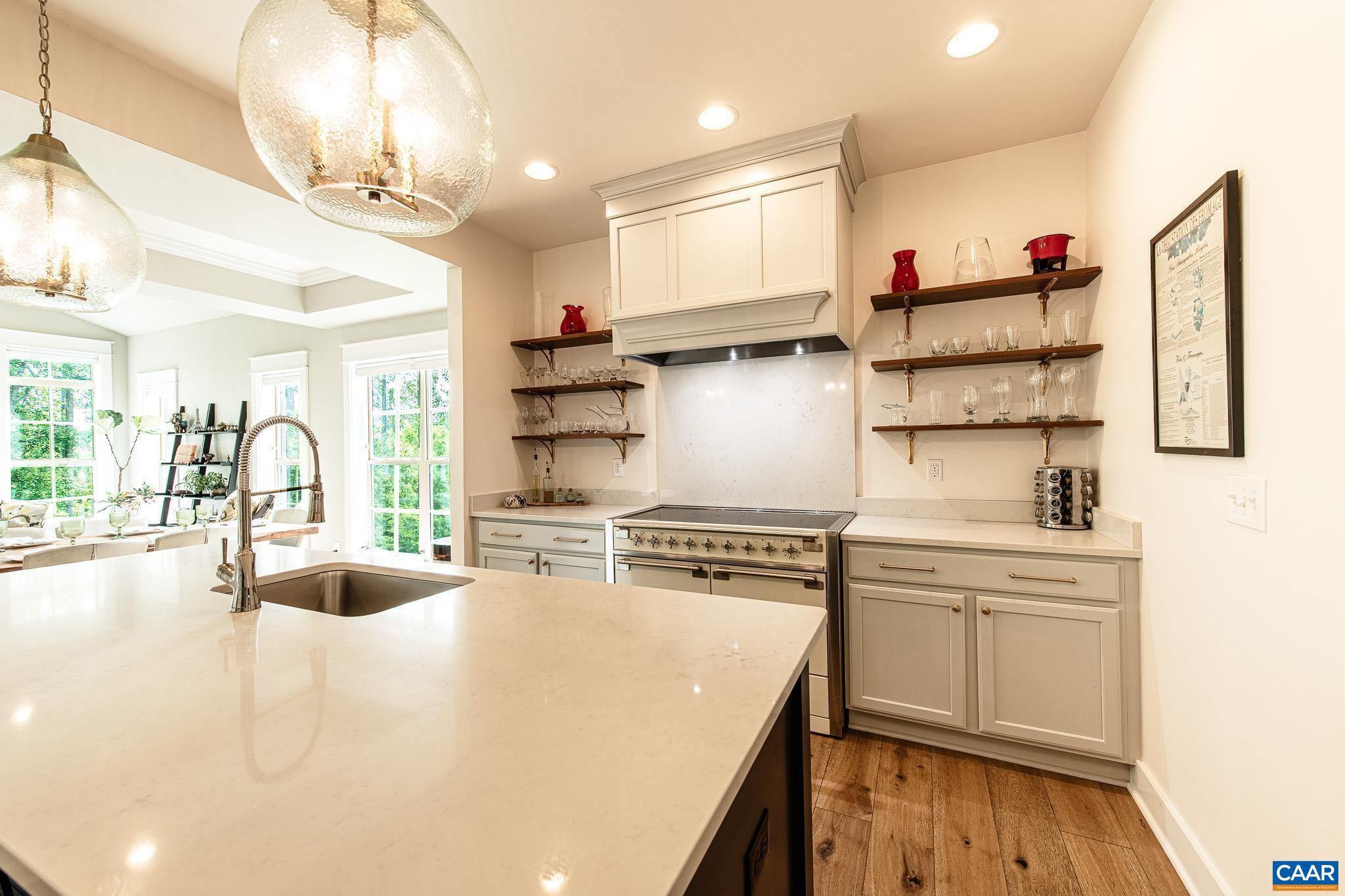 Discover this nearly-new, luxury home built in 2022 by Craig Builders, offering top-tier finishes and custom upgrades. Boasting an open floor plan, wide hardwoods, and two offices, the stunning kitchen features quartz counters, a 48" AGA induction range, and custom hood, flowing into a bright great room with cathedral ceilings and protected woods views. The owner's suite includes a spa-like bath with Carrera marble and towel warmer. Upstairs are a spacious loft, two bedrooms, and ample storage. The finished terrace level offers a versatile great room, a guest suite, and a shaded patio—perfect for entertaining. The whole-house generator leaves you protected from outages too! Located in Old Trail, walking distance to shops, dining, trails, and just a short drive to wineries and breweries. An ideal move-in ready home for the discerning buyer seeking elegance, comfort, and location.