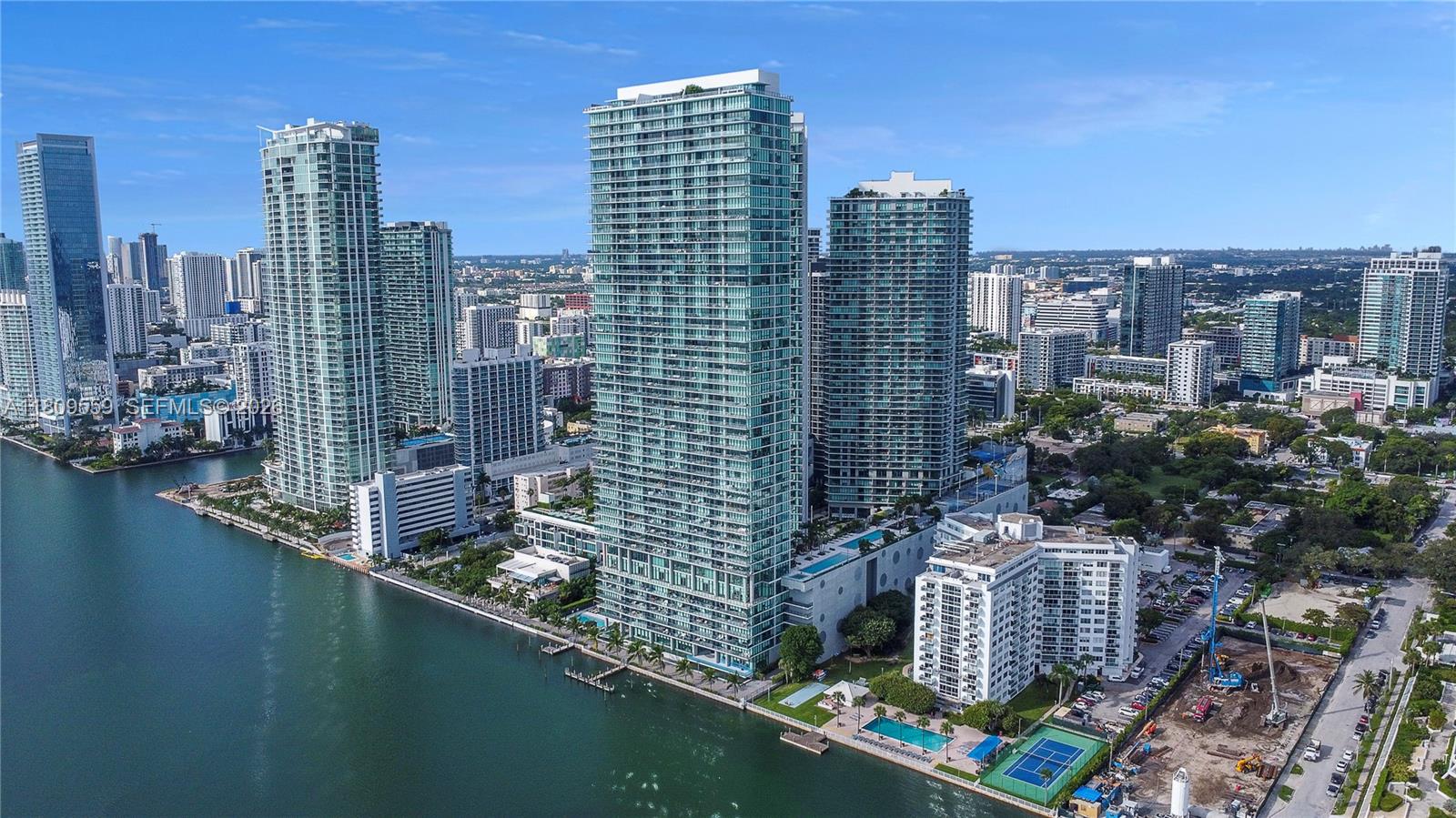 Welcome to One Paraiso 3104. Private elevator access opens up to your home in the sky. Floor-to-ceiling windows offer panoramic views of Miami Beach, Biscayne Bay, Port of Miami, Miami skyline. Split plan. Two large deep balconies. Open kitchen. Spacious living and dining room. Large primary bedroom. Large primary luxury bathroom. All bedrooms are en suite. Large den located between the 2 secondary bedrooms. Centrally located with quick access to Wynwood, Design District, Airport, Miami Beach, Downtown and Brickell. Two floors of amenities, including party room, business center, wine tasting area, children's rooms. Two pools, hot pools, cabanas, 2 tennis courts and BBQ area, massage room, billiards room, concierge, valet. A private oasis in Edgewater one of Miami's newest neighborhoods.