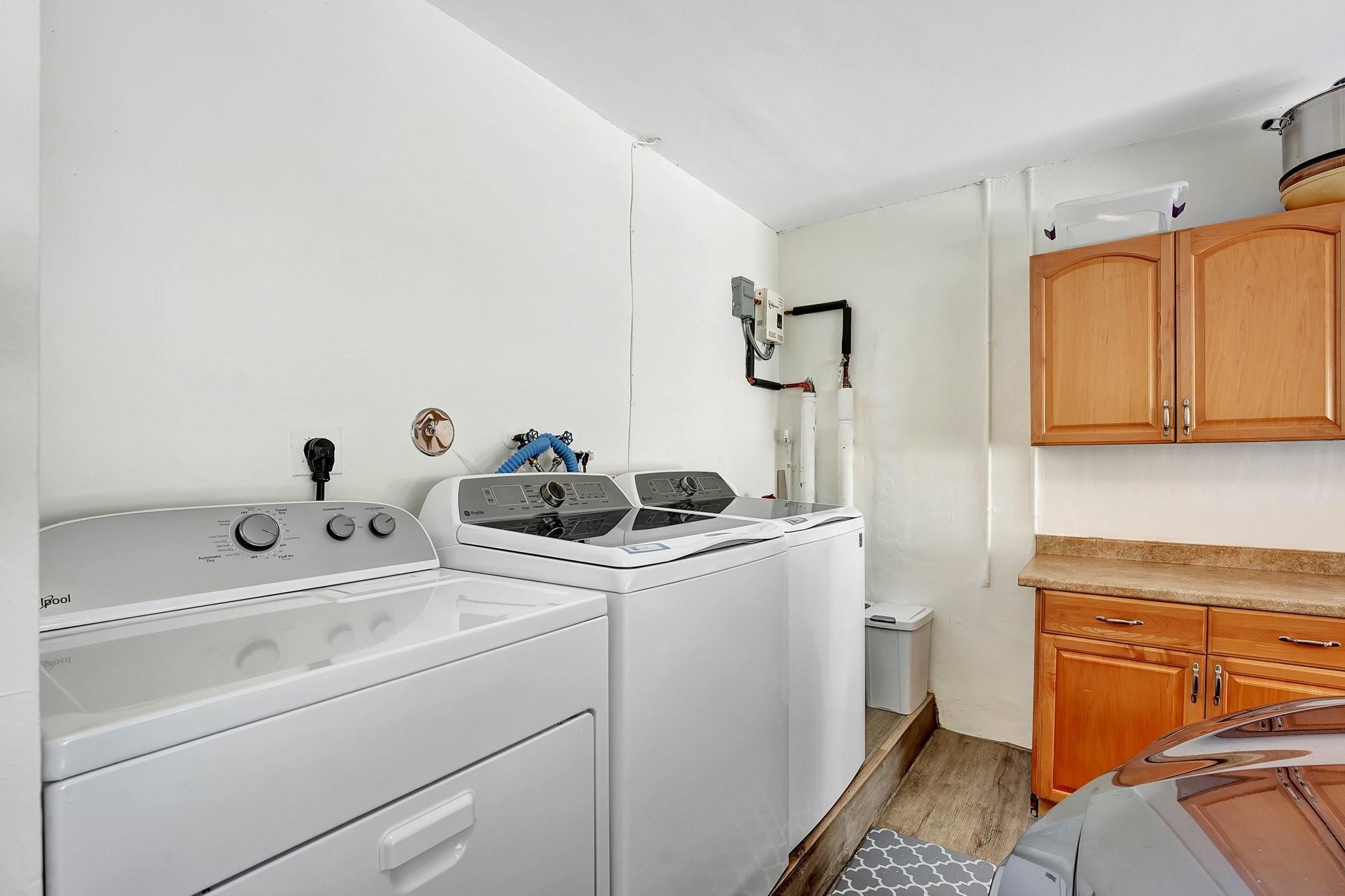 TWO WASHERS AND DRIER IN GARAGE