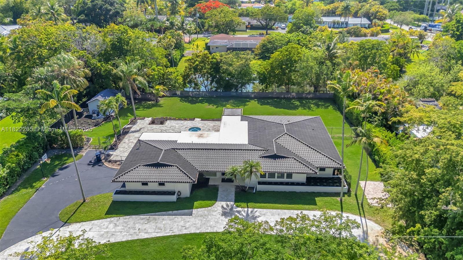 DREAM PROPERTY! PERFECT FOR FAMILIES, INVESTORS, OR SPEC BUYERS. WITH RECENT $500,000 UPGRADES, THIS SPACIOUS HOME ON A LARGE 30,000 SQ FT LOT OFFERS 3 BEDROOMS, 3 BATHROOMS, PLUS AN OFFICE OR 4TH BEDROOM, ENSURING ULTIMATE FLEXIBILITY & FUNCTIONALITY, WITH AIR-CONDITIONED 2-CAR GARAGE INCLUDES EPOXY FLOORING, TESLA CHARGER, SINK, GYM, TV, COUCH, & BIKE RACK. EVERY WINDOW & DOOR IS HURRICANE IMPACT RESISTANT FOR PEACE OF MIND.THE RESURFACED POOL, SURROUNDED BY A MARBLE TRAVERTINE PATIO, ENHANCES THE OUTDOOR SPACE. THE BIG BACKYARD ON A CANAL, ALONG WITH A BASKETBALL COURT, SECURE GATED ENTRANCE WITH A CIRCULAR DRIVEWAY PAVED IN MARBLE, ON A QUIET CUL-DE-SAC, NEAR SCHOOLS & SHOPPING, ADD TO THE PROPERTY’S APPEAL. PLUS, WITH AN IRRIGATION SYSTEM & HOME SECURITY SETUP, IT'S MOVE-IN READY.