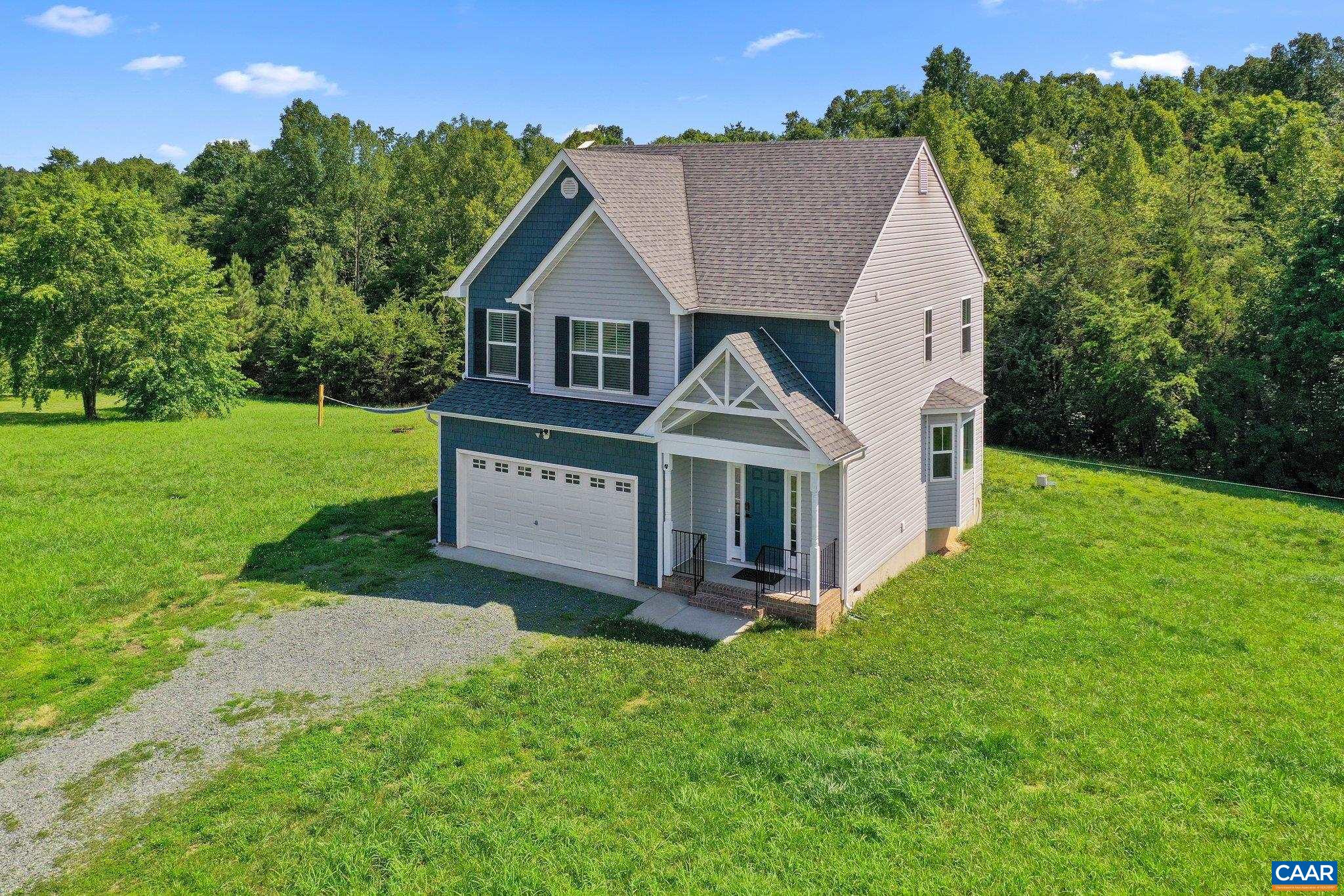 Charming 4BR/2BA home nestled in a quiet cul-de-sac with scenic pastoral and wooded views. Enjoy peaceful outdoor living on the spacious back deck overlooking the private backyard. Interior features include an open floor plan, abundant natural light, and neutral paint tones throughout. The main level boasts engineered hardwood floors and a large bay window in the breakfast nook.  The kitchen is well-appointed with white cabinetry, white countertops, island, and a modern black sink—ideal for cooking and entertaining. The primary suite includes an en suite bath with a white ceramic tile shower.  Additional highlights: Starlink Satellite internet (to convey), serene setting, and just under 20 miles to downtown Charlottesville. A perfect blend of comfort, privacy, and convenience.