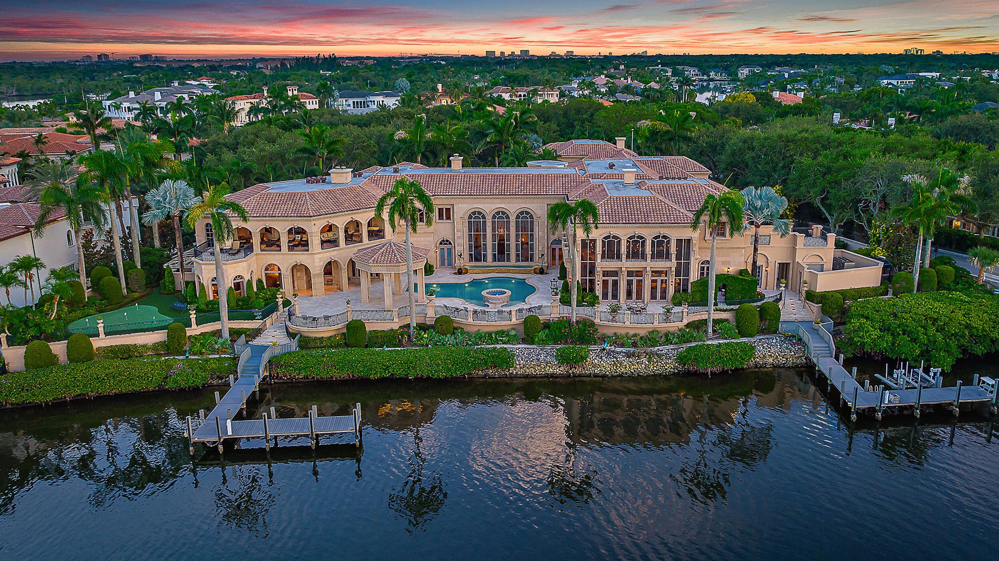 Introducing a palatial waterfront estate on a double lot in the exclusive community of Admirals Cove, where timeless design meets South Florida luxury. Situated on over 300 feet of prime water frontage with two private docks, this architectural masterpiece offers 9 bedrooms, 13 baths, and a lifestyle defined by elegance and ease. Ideal for yacht owners and water enthusiasts, the property offers exceptional access and capacity for large vessels or multiple watercrafts. Every detail of the interior has been thoughtfully curated--from soaring ceilings and rich finishes to spacious living areas designed for both grand-scale entertaining and private retreat. . A dedicated 3-bedroom guest house ensures comfort and privacy for extended family or visitors,   SEE MORE... while the 6-car garage provides ample space for car collectors and enthusiasts. The estate is a dream for entertainers, with a complete catering kitchen and wet bar, a formal dining room fit for large gatherings, and a club room upstairs featuring warm wood finishes, multiple seating areas, custom wood walls all overlooking breathtaking Intracoastal views. Enjoy alfresco dining by the water or unwind poolside surrounded by tropical serenity. Admirals Cove is one of Jupiter's most sought-after gated communities, known for its luxurious waterfront lifestyle, 45 holes of championship golf, tennis, a world-class marina, and a private country club with five-star amenities. Located in the heart of Jupiter, FL, residents enjoy easy access to pristine beaches, top-rated schools, fine dining, and everything that makes this coastal town one of Florida's most desirable places to live.