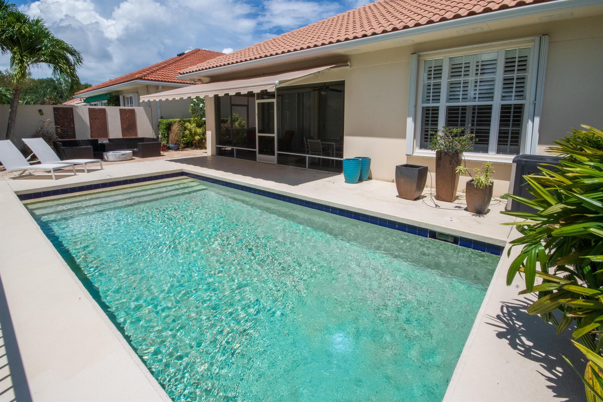 Charming & Private Lakefront Pool Home with extended Patio & deck area, Remote Sun-Shade Awning, lovely covered & screened Patio area & Lush Landscaping. Updated custom kitchen offering an entire suite of SS Appliances, a Pantry w/pullouts, a large L-shape bar counter topped with a sea of luscious quartz countertops & a window over the large SS sink. U'll also enjoy the convenient sliding door just off kitchen with side patio & outdoor grilling station. Open Concept living & dining area, Soaring Ceilings & NO POPCORN throughout. New flooring, Plantation Shutters, Murphy Bed, Most Popular, Divosta Built Solid Model: 3 bed/3bath/Plus Bonus Flex Rm/oversized 2 car garage/Laundry Rm with full size W&D, 6-Bays of 42'' Cabinets & Large Utility sink.GR8 Entertaining spaces inside & out. A MUST C More about this particular floor plan: 
Here you will find a covered &amp; screened front porch, a welcoming Foyer Entry, a lovely separate front room w/double French door entry which can be used as a Formal Dining Room, Den, Office,4th Bedroom/Flex/bonus room. There is an open concept living, dining, and kitchen area with with 2 sets of triple sliding doors out to the back covered patio &amp; pool area with a Covered and Screened back patio overlooking your own Private Pool, with Lush Landscaping and peek-a-boo lakefront views, and Remote Awnings providing Shade to enjoy all those glorious sunsets. You'll also find a large extended patio areas perfect for the Fire Pit and extended lounging &amp; entertaining. There is also an additional side patio with a marvelous grilling station conveniently located right off of the kitchen. The Master Retreat has a double door entry, plenty of room to house a king size bed and other substantial furniture pieces, as well as room for a reading corner. This private area also offers separate his &amp; her on-suite baths and his &amp; her custom closets, and views of pool, landscaped grounds and lake. The additional 2 bedrooms are on the opposite wing of the home and they too offer custom closets and and an additional bathroom. You may even enjoy doing laundry in this laundry room with its full-size washer and dryer, a deep, full size utility sink, and loads of extra cabinets and storage space. The 2 car attached garage has extra storage areas on 3 -sides, it houses the Central Vacuum system (motor outside-so quiet when running inside), Water Heater, Circuit Breaker Panel, and pull down attic access &amp; storage, 
More about the Exposure of this Property:  
Outside you will also find full accordion Miami-Dade Rated Storm Protection.
More about the Community of this property: 
LOCATION PERSONIFIED!!! As if everything this Premium Lakefront property and home has to offer wasn't already enough...There is more. This property is all tucked away in the highly sought after guard-gated, hidden gem of a community called Oaks East. Now for the whipped cream and cherry on top: Oaks East is a secure, guard-gated community (manned 24/7 by an onsite guardsperson). This community also offers magnificent, mature trees that form beautiful tunnels or canopies over the streets, user-friendly sidewalks with streetlamps, wooded preserve or common areas with benches, and lakes, unsurpassed landscaping, heated community pool, an onsite property manager, basic cable, and so much more. ALL included with VERY reasonable maintenance fees &amp; no costly or mandatory membership fees. Oaks Park offers a Heart Trail, two lit Tennis Courts, and Picnic Area. And all of this is privately tucked away off of a 25 mile an hour side street, yet so conveniently located you could walk to a multitude of shops, malls, and restaurants. Including the beautiful Gardens Mall (with loads of High end Shops), Legacy Place, &amp; Downtown at the Gardens)are also nearby. You will also find 'In and Out' boat storage just around the corner at Port 32, and there are so many fabulous Restaurants including River House, Seasons 52, and Waterway Caf+¬ (all on the Intracoastal Waterway), Carmines &amp; Angry Moon Cafe and Cigar Bar on the Marina. You will also find grocers like Publix, Whole Foods, Trader Joes, Carmines Market, and Doris Market (Josephs Market is also in the area but you would likely drive from Oaks East to get there), There are other nearby shops within walking distance as well like Bed, Bath &amp; Beyond, Staples, CVS Drug Stores, Marshals, TJ Max, ACE Hardware, Publix Grocers(Lowes, Home Depot, &amp; HomeGoods, Josephs Market are off of Military &amp; North Lake, but also nearby). Also within walking distance of Oaks East you will find the beautifully renovated public library, the Eissey Campus Theater, the North County Municipal Center, the Driver's License Bureau, the Palm Beach Gardens Medical &amp; Emergency Center (A rated heart and stroke hospital). Medical imaging centers, blood-work facilities, and other health providers are also right around the corner-so if (God forbid) there was an emergency you wouldn't have to worry about getting caught at the railroad tracks or at a waterway bridge (the Bridges go up on the 1/2 hour and only if there is a boat big enough to open the bridge for, so you can time your trips over the bridge). Oaks East is also just around the corner from the Intracoastal Waterway and area Beaches (also so close you could walk or ride a bike), and if you have a boat you can keep it in one of the near by marinas or at the in &amp; out boat storage (also just around the corner). A short drive west on PGA you will find hundreds of more fabulous shops and restaurants. Oaks East also offers nearby access to I-95 and the Turnpike and is only a 20 minute drive to the International Airport. What are you waiting for??? Don't walk, run to make this house your dream home today!!!