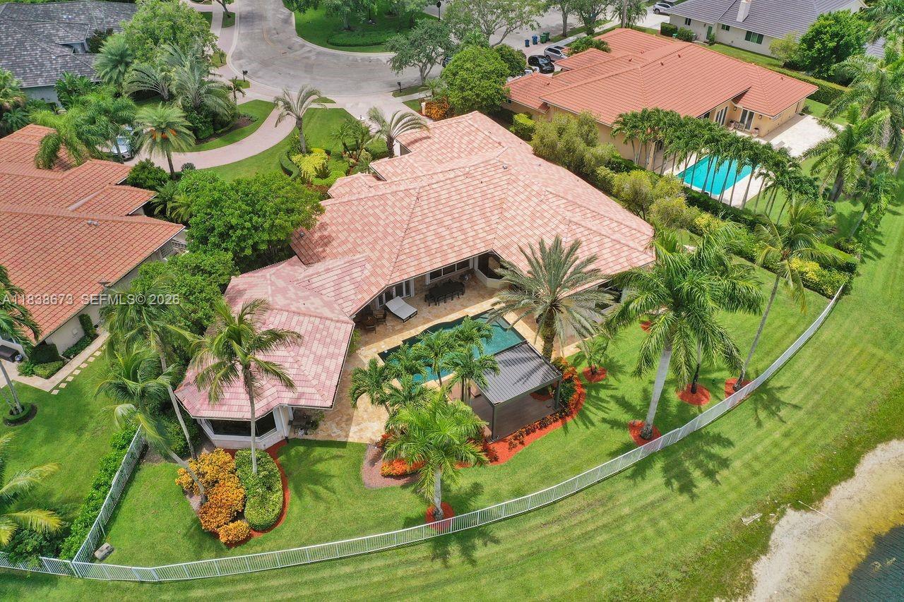 We are pleased to present this rarely available home in WHCC with huge 1/1 Guest House on over 1/2 acre waterfront point lot! Best price per sqft in Weston .This was built by Issa and is one of the largest one-story homes in WHCC with over 6500 sf total area and 6 bedrooms and 4 bathrooms in main house. Home is located in a cul-de-sac with 3 car garage and driveway for multiple cars. Home has a beautiful open split floor plan with high ceilings and views of lake from all main areas. Kitchen w/ granite, wolf & Viking appliances, real hardwood flooring and beautifully updated bathrooms, accordion shutters etc. Only a few homes with this large guest house with views of lake. Absolutely stunning remodeled outdoor pool area with tumbled marble pavers and gorgeous wide lake views. Bring all offers!!