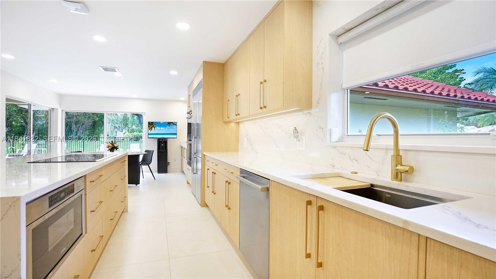 Stunningly renovated home in exclusive Delaire CC with 24-hour security and a new 27-hole golf course—no tee times required! On a corner 0.42-acre lot, this 2024-renovated home features a new roof, 4 new AC units, impact windows/doors, modern kitchen with BOSCH appliances, Sub-Zero fridge, 48x48 tiles, 5 custom bathrooms, and solid wood interior doors. Enjoy a saltwater pool, full outdoor kitchen with pizza oven, BBQ, stove, and more. Plus, a renovated 2-bedroom guesthouse with private entry. Community offers fitness, tennis, sauna, playground, and social events. Book your private showing today. Please see broker remarks