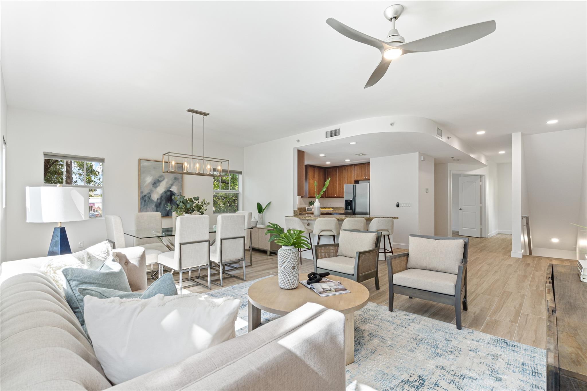 Rarely available four-bedroom townhouse in Harbor Vista featuring new porcelain wood-look flooring, high ceilings, and an open, light-filled layout. The kitchen offers granite counters, stainless steel appliances, and solid wood cabinetry. Spacious primary suite includes a bonus room, separate tub and shower, and walk-in closet. Two-car garage. Prime location near the airport, beaches, Las Olas, and top-rated schools.