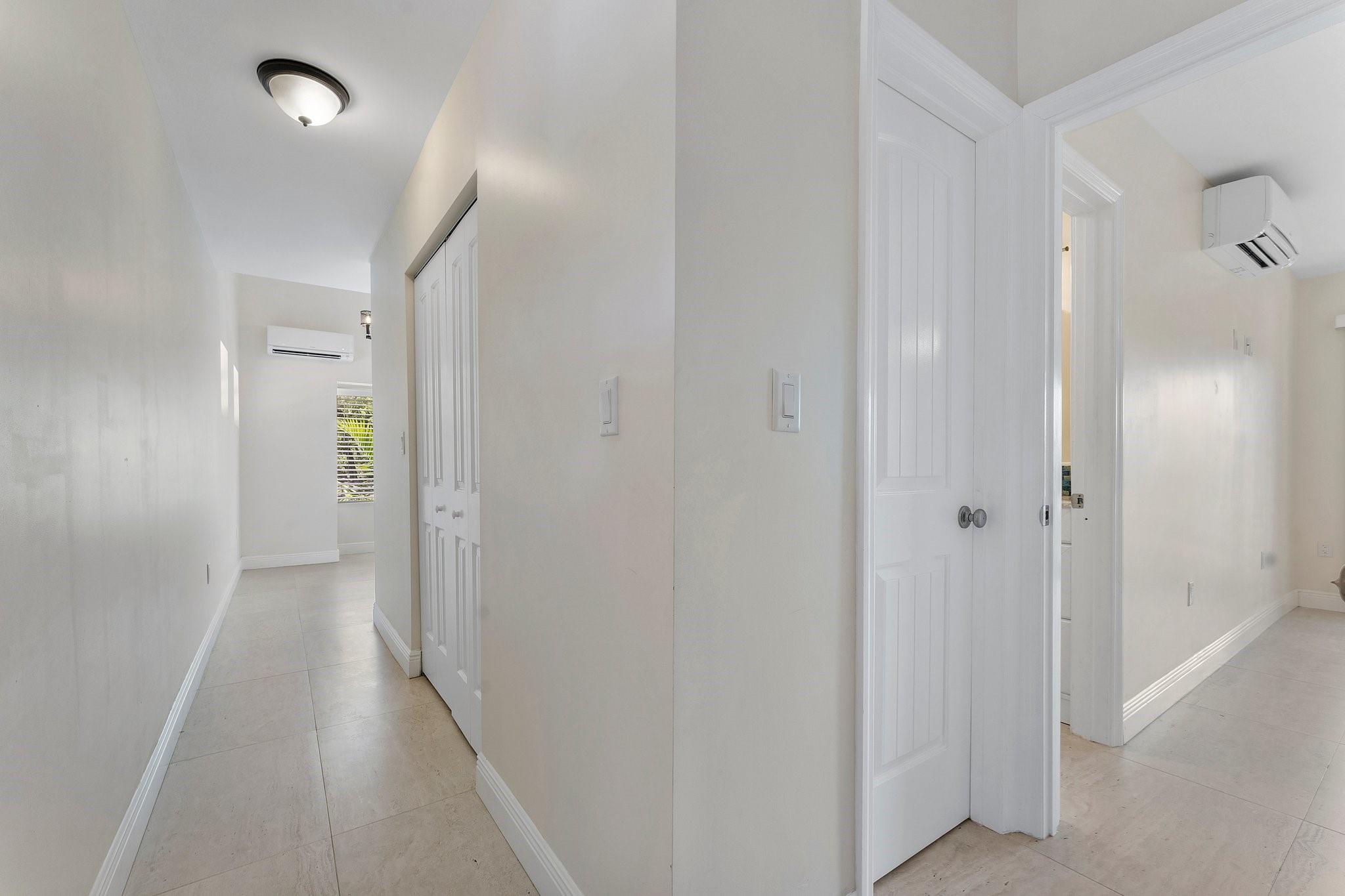 Hallway outside bedroom #4 & #5. The doors open to laundry room